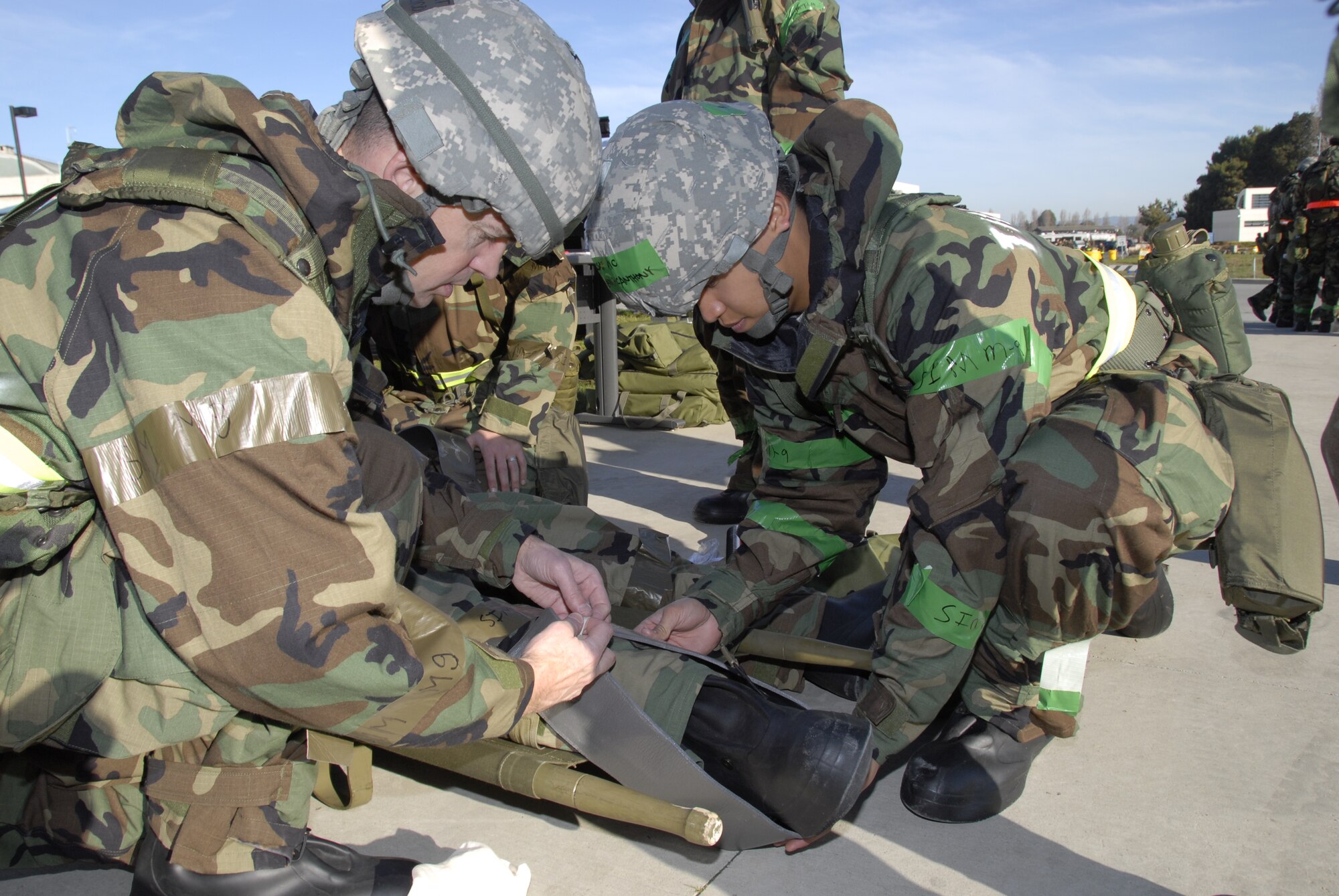Two members from the 129th Rescue Wing apply a splint on an Airman's simulated leg injury during war skills training at Moffett Federal Airfield, Calif., Feb. 5, 2011. The 129th Rescue Wing is preparing for an upcoming Operation Readiness Inspection in December 2011.  (Air National Guard photo by Tech. Sgt. Ray Aquino/RELEASED)