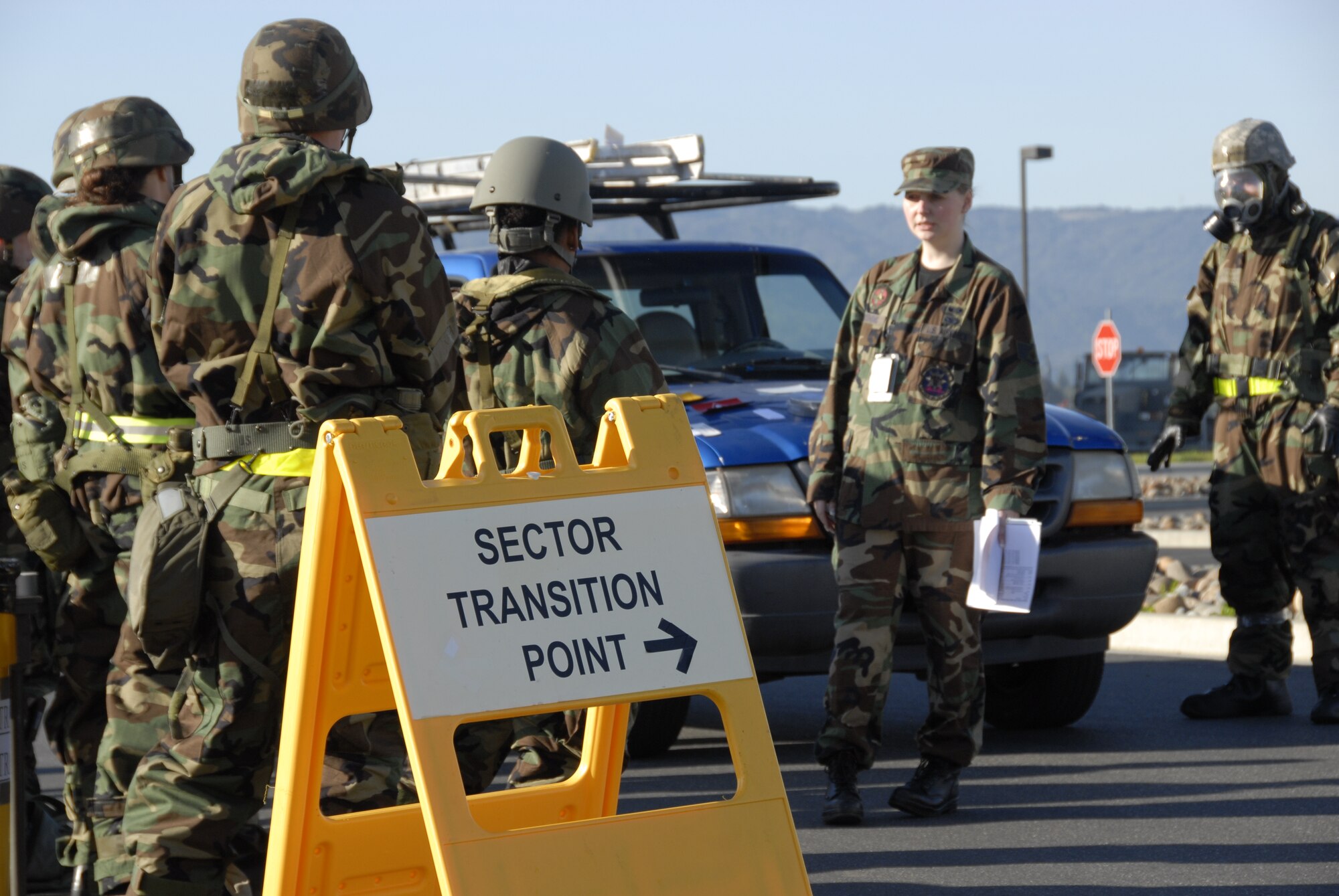Staff Sgt. Alana Groshong, an emergency management technician from the 129th Civil Engineering Flight, briefs proper sector transition precedures to members dressed in Mission Oriented Protective Posture suits during war skills training at Moffett Federal Airfield, Calif., Feb. 5, 2011. The 129th Rescue Wing is preparing for an upcoming Operation Readiness Inspection in December 2011. (Air National Guard photo by Tech. Sgt. Ray Aquino/RELEASED)