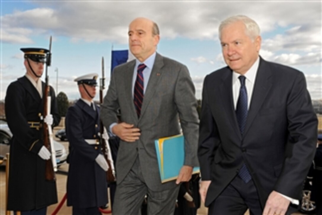 Secretary of Defense Robert M. Gates (left) escorts French Minister of Defense Alain Juppe through an honor cordon and into the Pentagon on Feb. 8, 2011.  Gates and Juppe will hold security discussions on a broad range of topics including the increasing congestion in Earth orbit from multi-national space programs.  