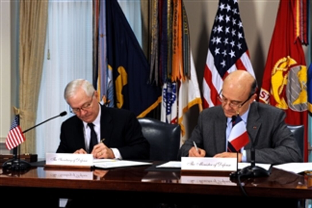 Secretary of Defense Robert M. Gates (left) and French Minister of Defense Alain Juppe (right) sign a document entitled "Space Situational Awareness Partnership Statement of Principles" in the Pentagon on Feb. 8, 2011.  Gates and Juppe expressed their concern in statements to the press over the increasing congestion of space vehicles from multiple nations in Earth orbit.  