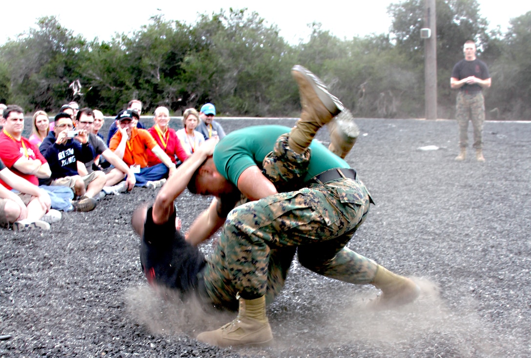 Two Marine Corps Martial Arts Instructors demonstrate some moves that are part of the Marine Corps Martial Arts Program that every Marine learns in recruit training. The educators were encouraged to try out some basic moves under the supervision of the MAI’s, Feb. 08.