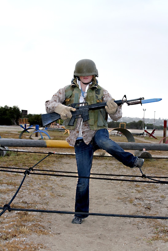 Jodi Meyerson, English teacher, American Leadership Academy, South Spanish Fork, Utah, maneuvers through a field of simulated tripwires while running the bayonet assault course Feb. 8.