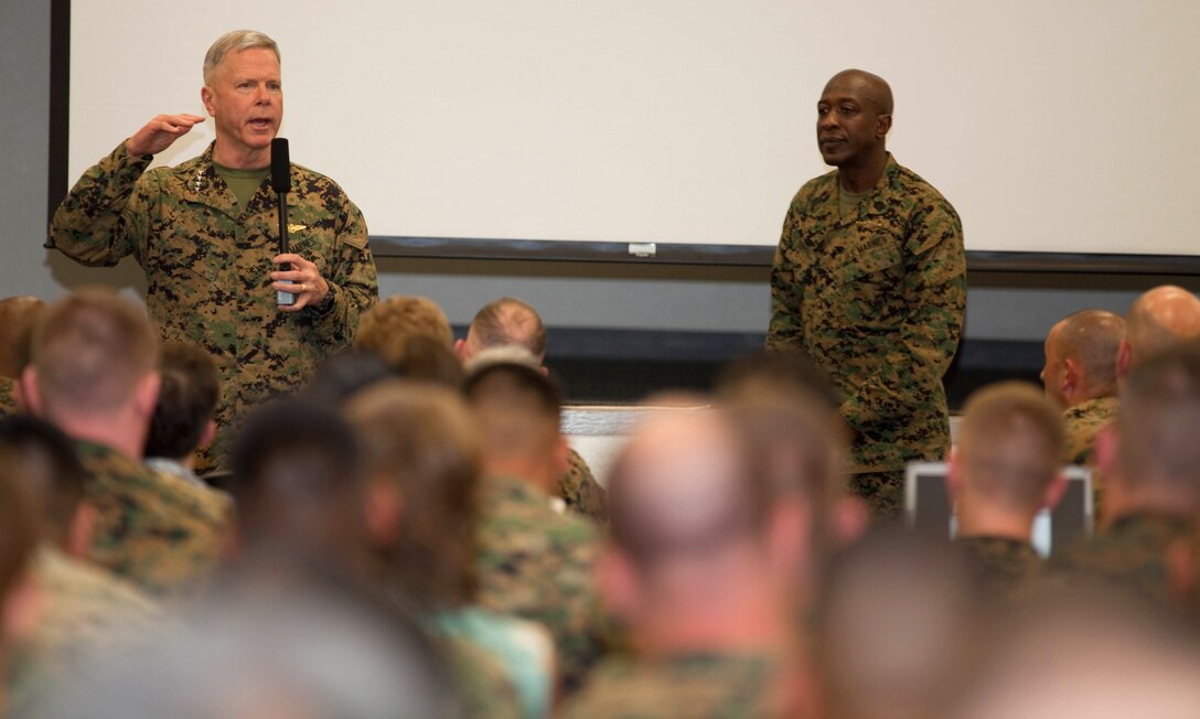 Gen. James F. Amos, commandant of the Marine Corps, speaks with Marines, Sailors and civilian Marines assigned to U.S. Marine Corps Forces, Pacific, and U.S. Pacific Command during a town hall meeting Feb. 9 at the MarForPac headquarters building, here.::r::::n::During his visit, Amos wanted to stress the responsibility of every Marine to keep the spirit of the Corps alive.::r::::n::“We are all, regardless of rank or title, Marines,” he said.