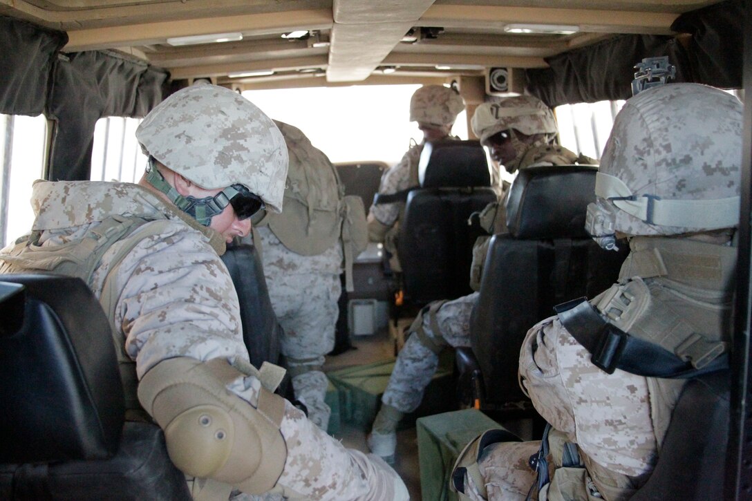 Marines with 2nd Combat Engineer Battalion from Marine Corps Base Camp Lejuene, N.C., strap up in the Mine Resistant Ambush Protected (MRAP) Egress Trainer, a rollover simulation at the Battle Simulation Center in Camp Wilson Feb. 9, 2011.