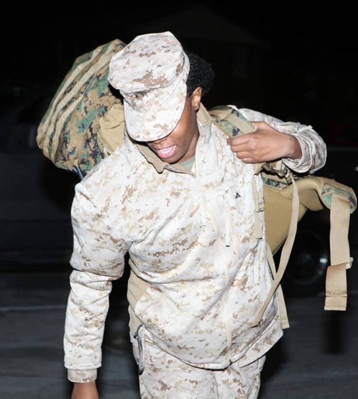 Lance Cpl. Shiquesha T. Howard, an aviation operations specialist with 2nd MAW (Fwd.) shoulders her pack bound for Afghanistan's Helmand province prior to departing Marine Corps Air Station Cherry Point, N.C., Feb. 9.