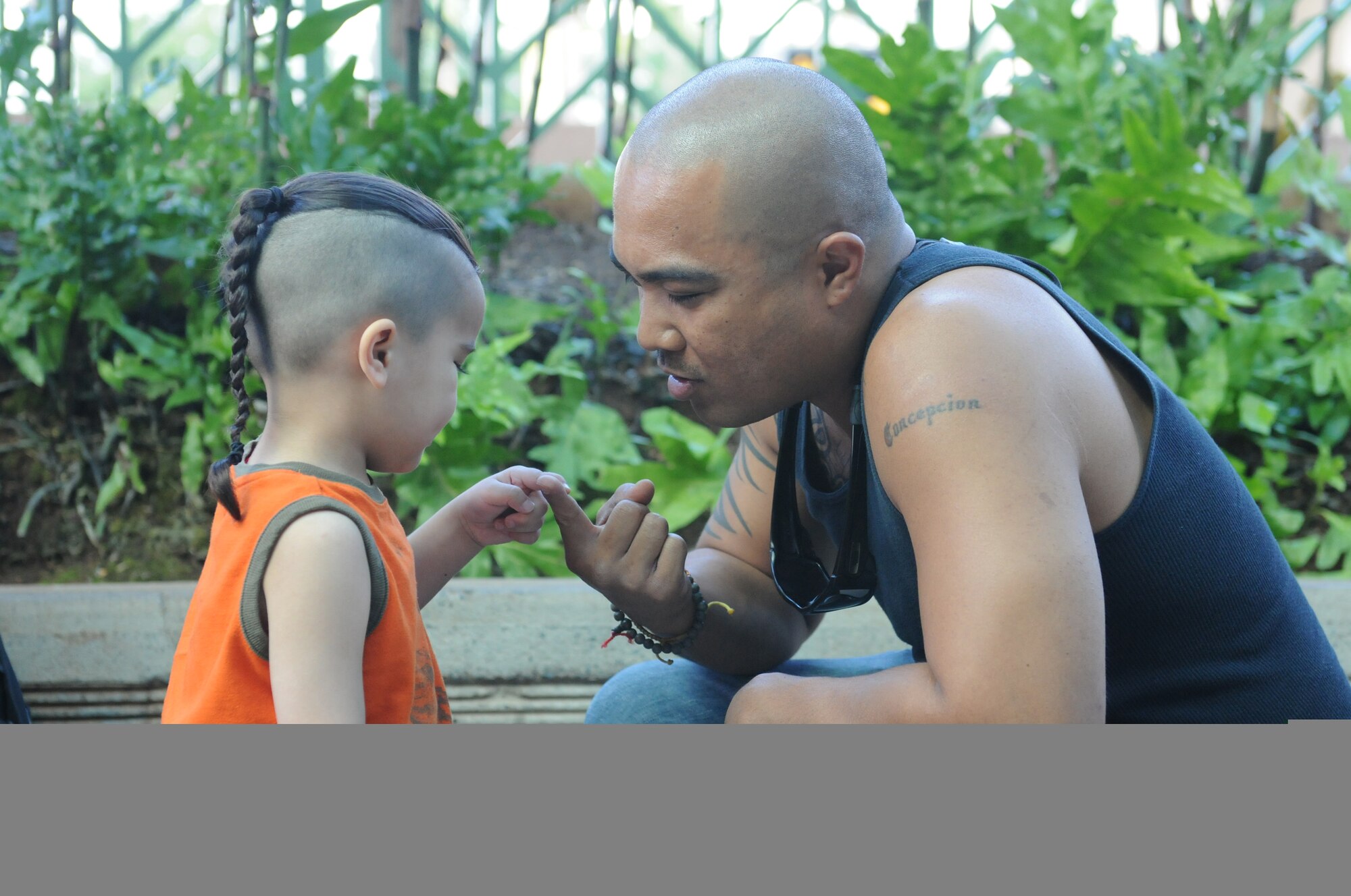 HONOLULU INTERNATIONAL AIRPORT, Hawaii -- U.S. Air Force Reserve Master Sgt. Sean Concepcion, 48th Aerial Port Sqaudron, 624th Regional Support Group, spends time with his son, Ryder, before boarding a plane here Jan. 24. Sergeant Concepcion is joining other 48 APS servicemembers stationed at Hickam Air Force Base, Hawaii, for an extended deployment to Southwest Asia in support of contingency operations. They will be working alongside other Air Force APS Airmen in conducting ramp operations, processing cargo and passengers. (U.S. Air Force photo/Tech. Sgt. Steve Lewis)