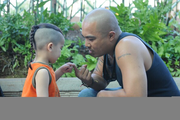 HONOLULU INTERNATIONAL AIRPORT, Hawaii -- U.S. Air Force Reserve Master Sgt. Sean Concepcion, 48th Aerial Port Sqaudron, 624th Regional Support Group, spends time with his son, Ryder, before boarding a plane here Jan. 24. Sergeant Concepcion is joining other 48 APS servicemembers stationed at Hickam Air Force Base, Hawaii, for an extended deployment to Southwest Asia in support of contingency operations. They will be working alongside other Air Force APS Airmen in conducting ramp operations, processing cargo and passengers. (U.S. Air Force photo/Tech. Sgt. Steve Lewis)