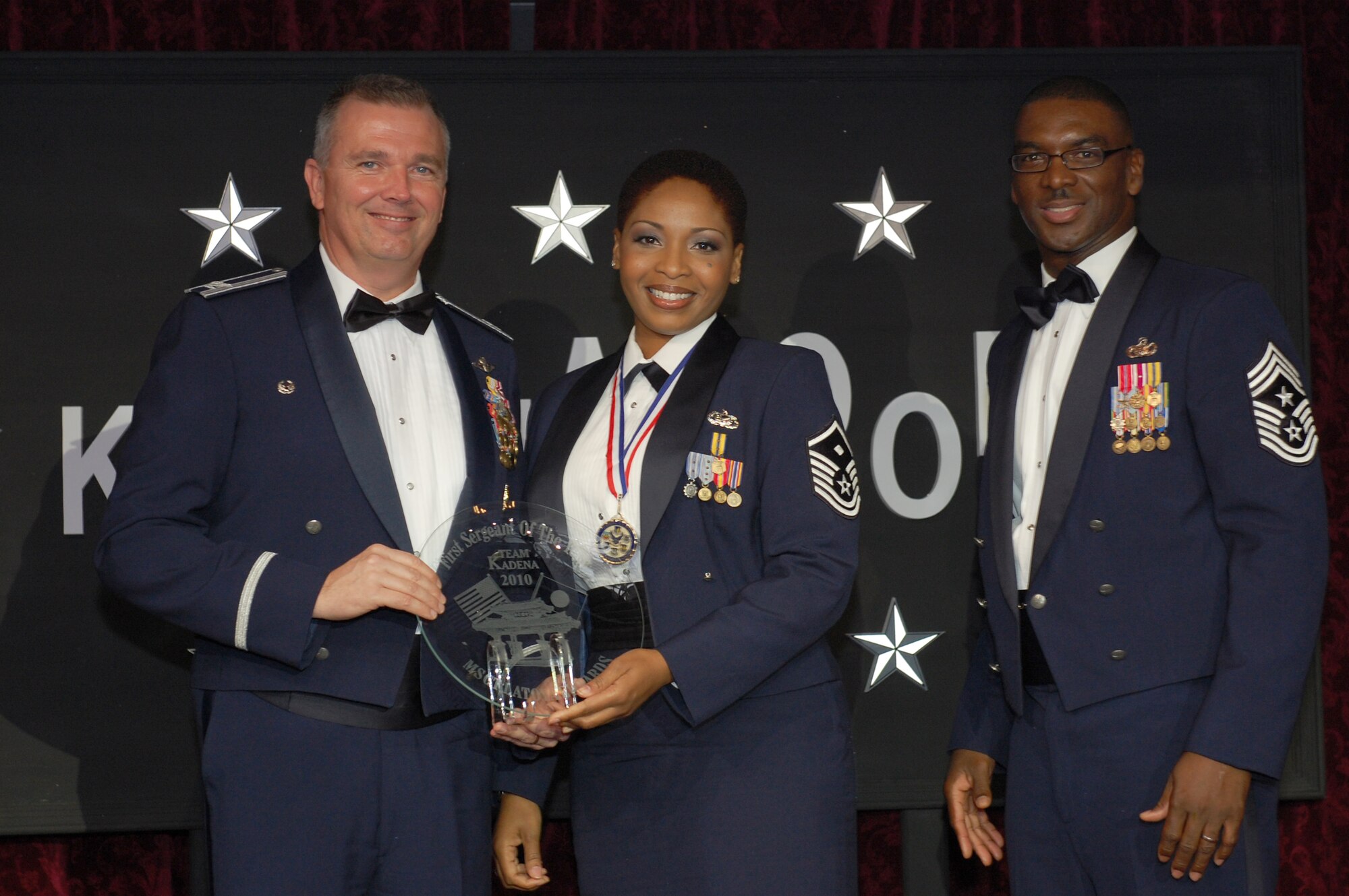 KADENA AIR BASE, Japan -- Master Sgt. LaToya Edwards (center), the 320th Special Tactics Squadron first sergeant, poses for a photo with Col. Ricky Rupp (left), the 18th Wing vice commander, and Chief Master Sgt. James Davis, the 18th Wing command chief master sergeant, after being named Team Kadena's 2010 First Sergeant of the Year  Feb. 5 at the 2010 Team Kadena Annual Awards  dinner. (U.S. Air Force photo by Staff Sgt. Lakesha Croley)