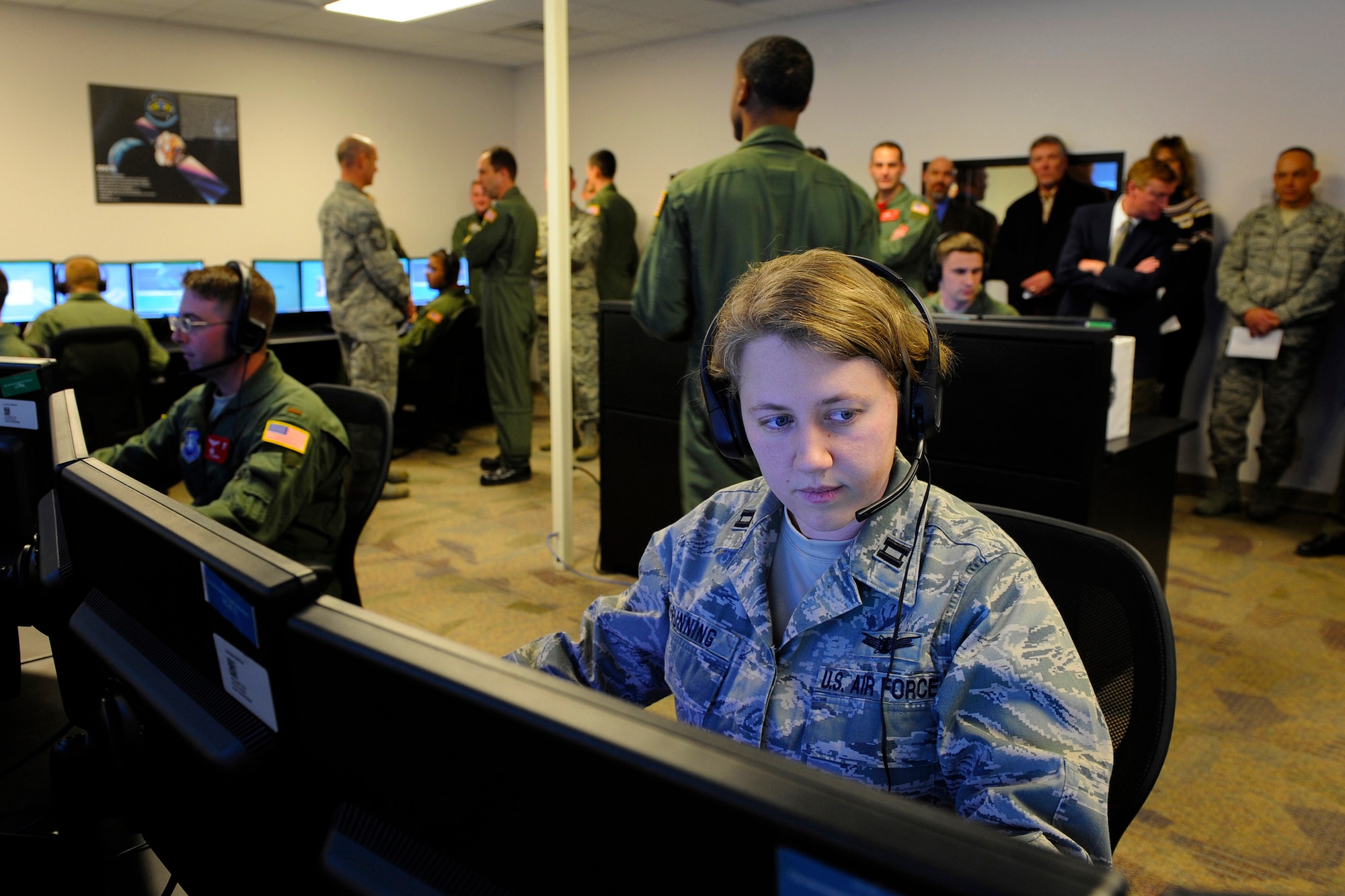 Capt. Jennifer Gunning sits at a student station in the new Standard Space Trainer Integrated Training Center  following a ribbon cutting that signified the official opening of the new system Feb.4, 2011, at Schriever Air Force Base, Colo. Captain Gunning is assigned to the 50th Operational Support Squadron. (U.S. Air Force photo/Dennis Rogers)
