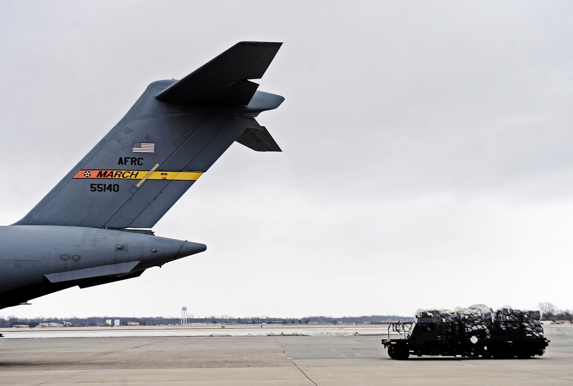 Officials in a cargo truck from the 375th Logistics Readiness Squadron pull up behind a C-17 Globemaster III to load humanitarian aid supplies Feb. 7, 2011, at Scott Air Force Base, Ill. (U.S. Air Force photo/Staff Sgt. Ryan Crane)