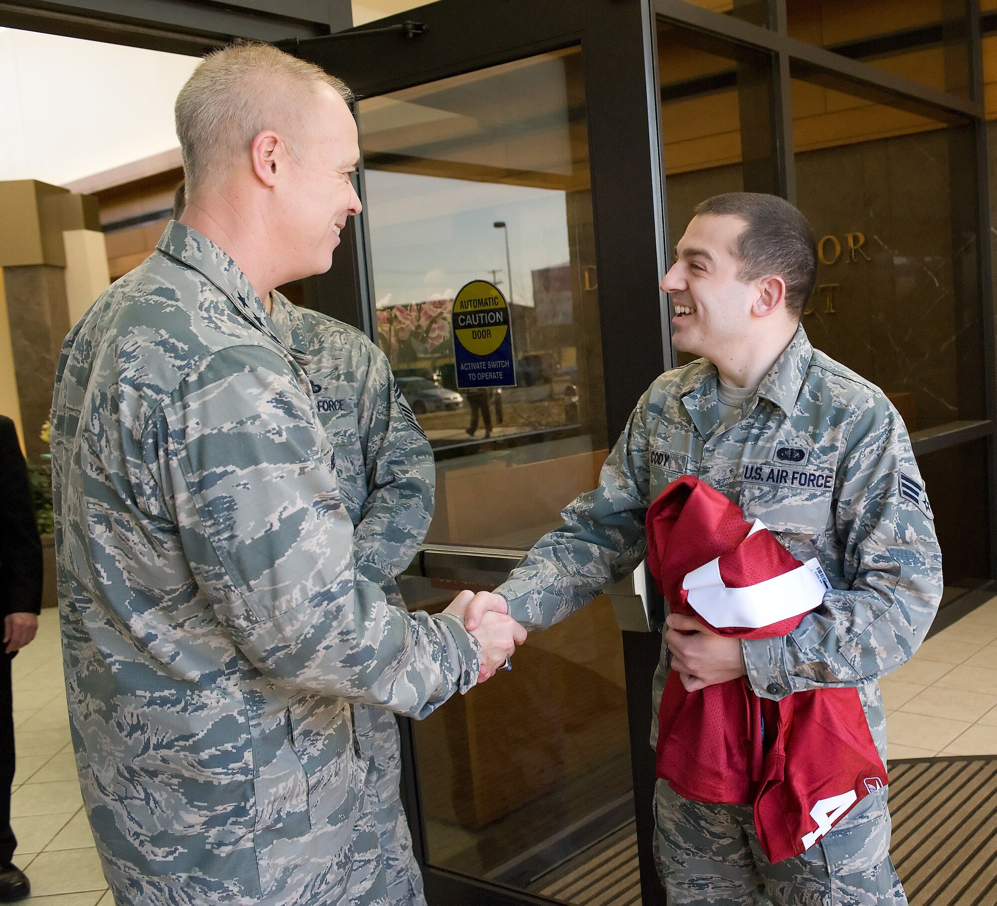 TRAVIS AIR FORCE BASE, Calif. -- Senior Amn. Gregory Cody, 349th Memorial Affairs Squadron, meets Lt. Gen.Richard Y. Newton III, the Air Force assistant vice chief of staff, Feb. 2, 2011. (U.S. Air Force photo/Jason Minto)
