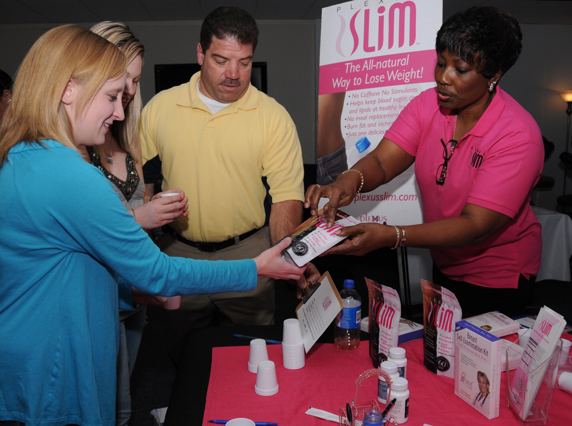 From left, Bethanne Ruyan and Ashley Ives receive samples from Dean Lepoma and Debra Toler from Plexus Slim during Spa Night, Feb. 5.  Their husbands, Airmen 1st Class Adam Ruyan and Sean Ives, are students in the 338th Training Squadron.  (U.S. Air Force photo by Kemberly Groue)