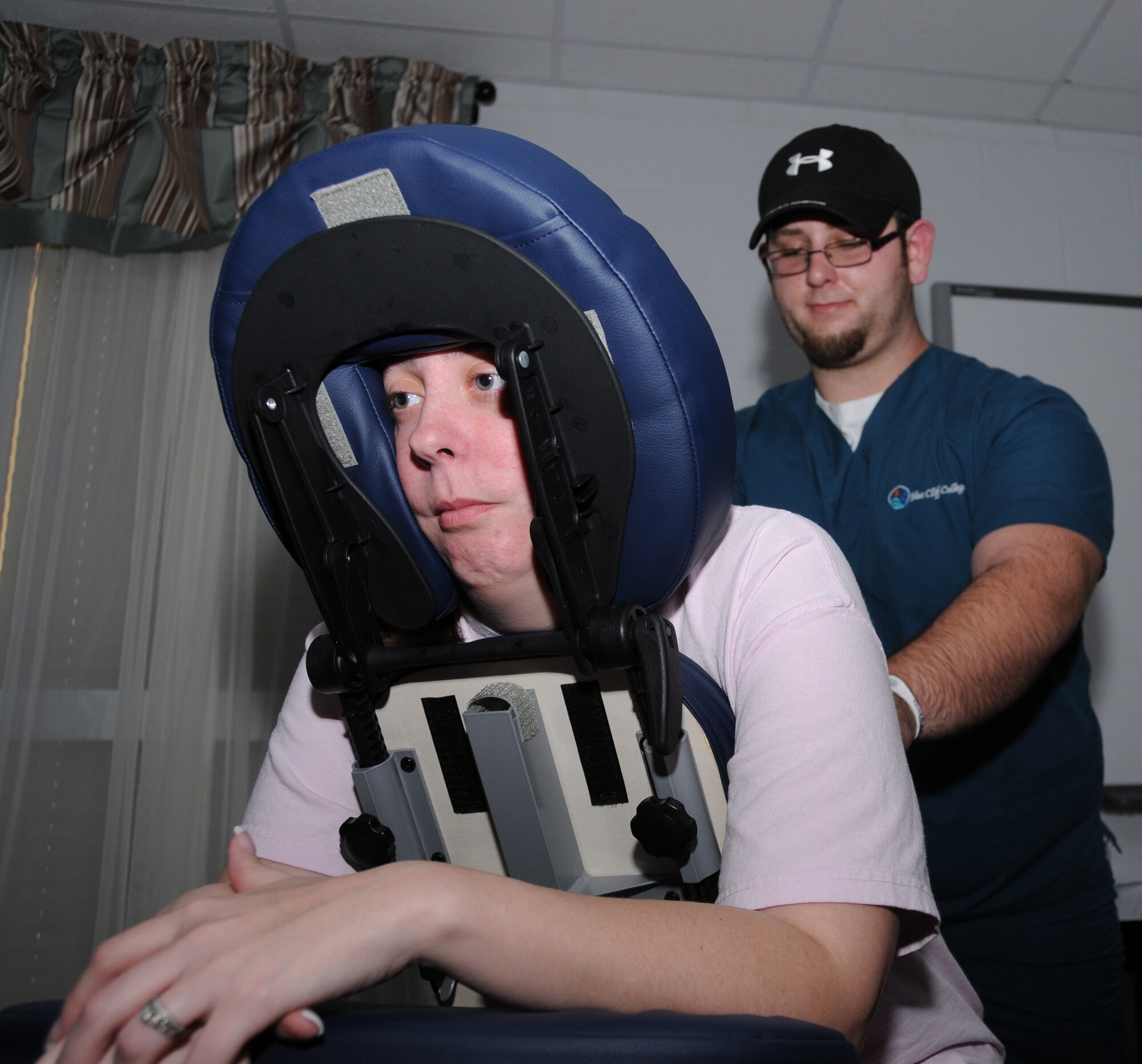 Left, Staff Sgt.AmandaMargavich, 81st Force Support Squadron, gets a massage from Michael Rivers, a massage therapy student from Blue Cliff College. Her husband, Staff Sgt. Brian Margavich, 333rd Training Squadron, is deployed to Cuba.  (U.S. Air Force photo by Kemberly Groue)