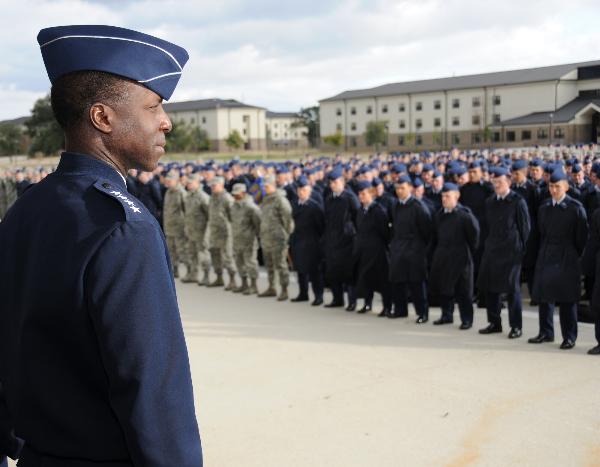 Gen. Edward Rice Jr., Air Education and Training Command commander, surveys technical training students from the 81st Training Group before his speech Monday on the Triangle parade field. General Rice visited Monday and Tuesday to meet with 81st Training Wing and 2nd Air Force leaders, become familiar with the base's training programs and facilities and get acquainted with some of Keesler's students and organizations.  He was accompanied by his wife, Teresa, and AETC's command chief, Chief Master Sgt. James Cody, and his wife, Athena.  (U.S. Air Force photo by Kemberly Groue)
