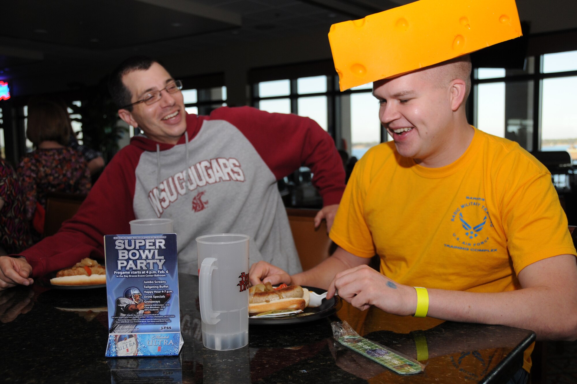 Airman 1st Class Robert Fraki, 338th TRS, declares his love for the Green Bay Packers by balancing a block of cheese on his head. Airman 1st Class Jonathan Gingas, 338th
TRS, joins his fellow Packer fan to cheer on their favorite team.  (U.S. Air Force photo by Kemberly Groue)