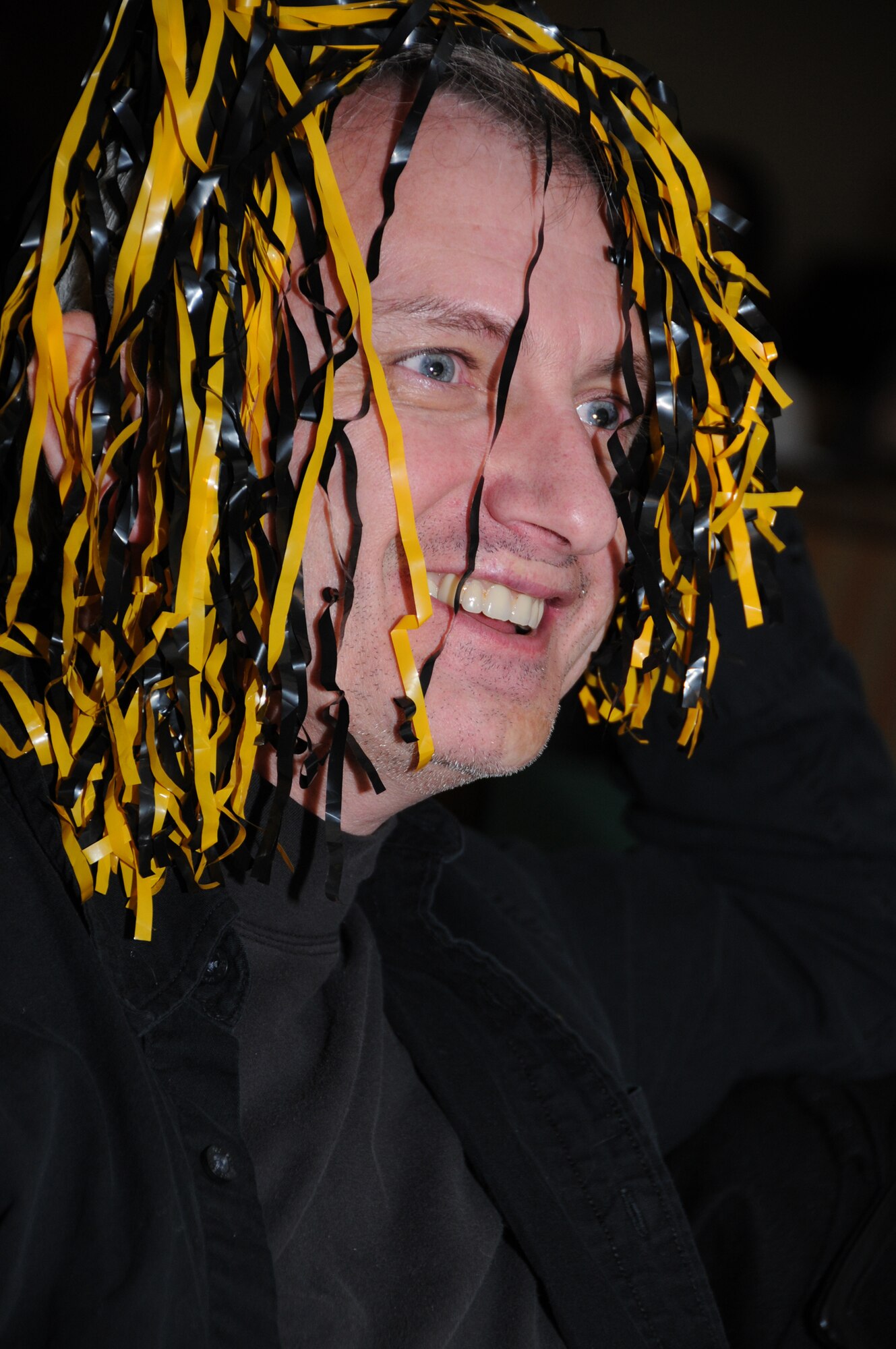 Left, Pittsburgh Steelers fan Barry Newman, 81st Training Wing, reveals his true black
and gold colors hoping to see his team win its seventh Super Bowl title. But with a smile on his face, it’s likely this picture was taken before the end of the game in which the Steelers lost to the Green Bay Packers, 31-25.  (U.S. Air Force photo by Kemberly Groue)