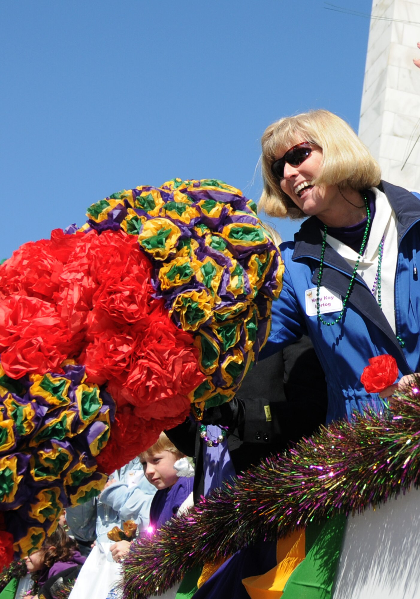 Maj. Gen. Mary Kay Hertog, 2nd Air Force commander, accepts a crepe paper flower
from a member of the Ole Biloxi Marching Club at last year’s Gulf Coast Carnival
Association parade in Biloxi.  (U.S. Air Force photo by Kemberly Groue)
