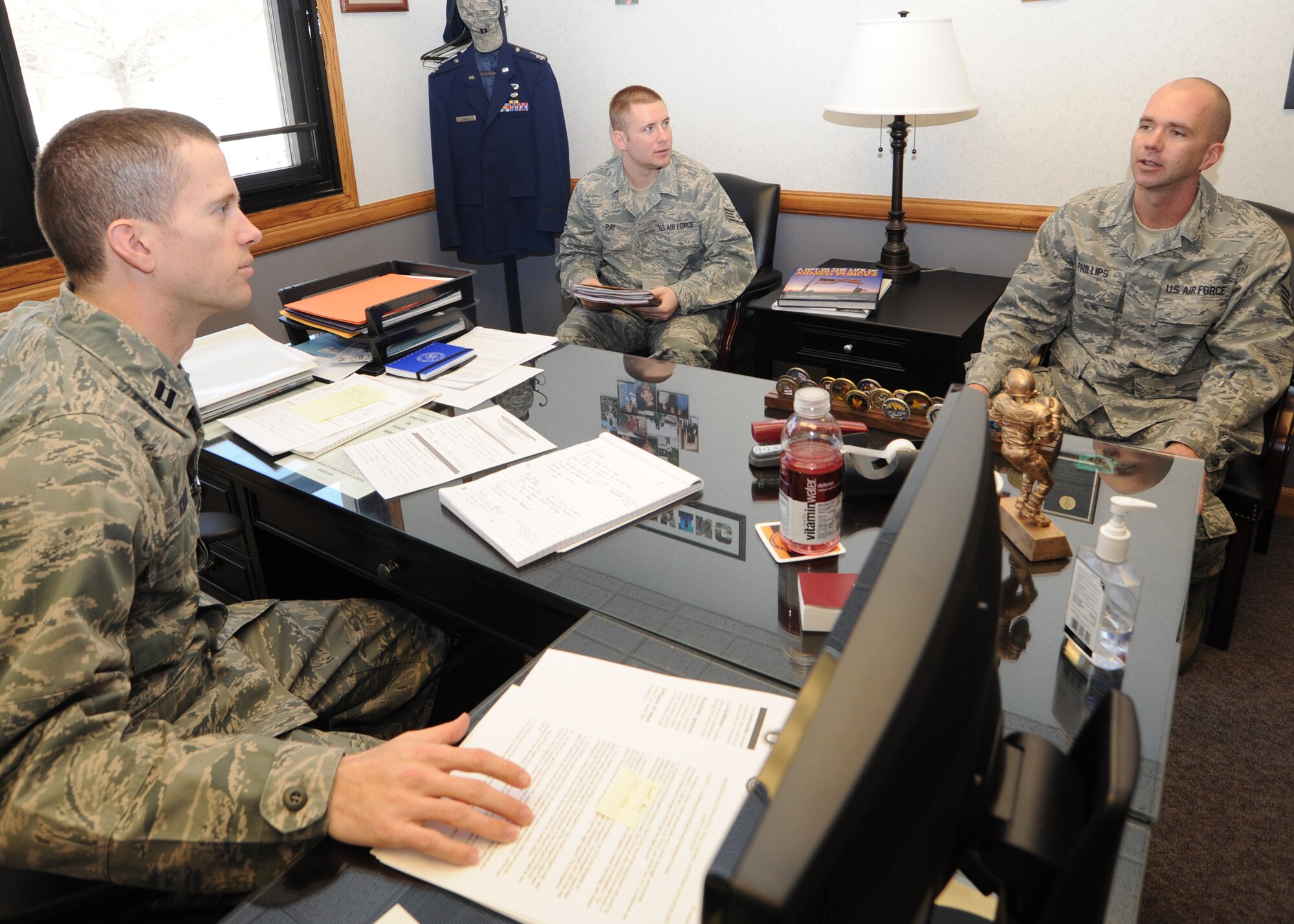 Capt. Sam Kidd, 22nd Air Refueling Wing chief military justice, and Staff Sgt. Robert Ray, 22nd Air Refueling Wing adverse actions NCOIC, speak to Master Sgt. Christopher Phillips, 22nd Maintenance Squadron first sergeant Feb. 9, 2011, McConnell Air Force Base, Kan. The legal office assists first sergeants with issues in their squadron. The legal office is the legal advisor to the wing commander, and they work closely with McConnell’s Sexual Assault Prevention and Response Program, Office of Special Investigations and other base agencies. (U.S. Air Force Photo/Airman 1st Class Katrina M. Brisbin)