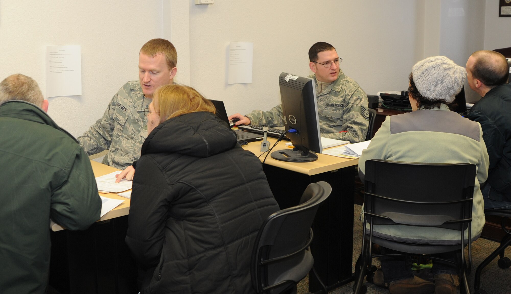 Staff Sgt. Darren Dobelman, 22nd Maintenance Operations Squadron maintenance operations controller, and Tech Sgt. Ken Harrison, 22nd Communications Squadron installation spectrum manager, assist Team McConnell members with filing their tax returns Feb. 8, 2011, McConnell Air Force Base, Kan. Sergeant Dobelman and Harrison are certified under Internal Revenue Service Volunteer Income Tax Assistance and Tax Counseling for the Elderly program, to assist Team McConnell taxpayers with free tax return filing. McConnell’s legal office helps run the base tax center and gives legal advice to tax payers. (U.S. Air Force Photo/Airman 1st Class Katrina M. Brisbin) 