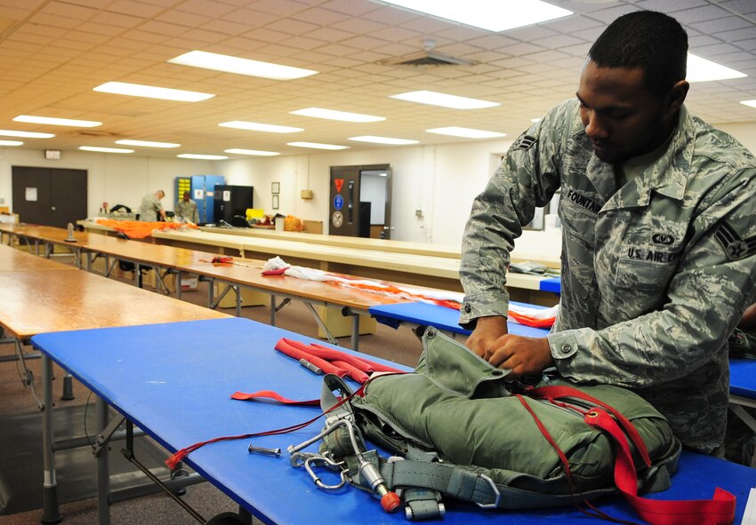 MOODY AIR FORCE BASE, Ga.-- Senior Airman Roderick Fountain, 347th Operations Support Squadron aircrew flight equipment journeyman, ties down the parachute harness Feb. 9. Each parachute takes roughly three hours to pack. (U.S. Air Force photo/Senior Airman Stephanie Mancha)(RELEASED)