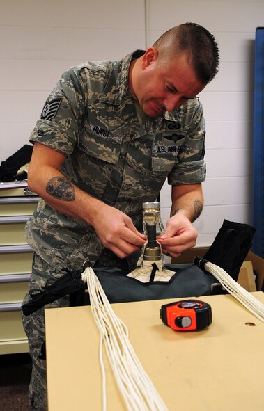 MOODY AIR FORCE BASE, Ga. -- Tech. Sgt. Wade Hurst, 76th Fighter Squadron aircrew flight equipment NCO in charge, works on the advance concept ejection seat II (ACES II) parachute system for the A-10C Thunderbolt II Feb. 9. It takes about three and a half hours to pack a parachute into an ACES II system. (U.S Air Force photo/ Senior Airman Stephanie Mancha)(RELEASED)