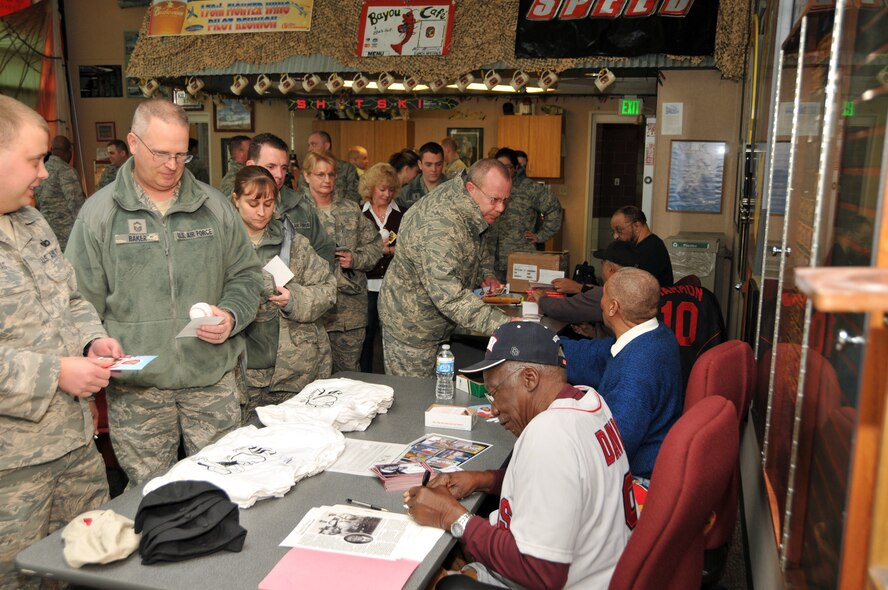 Charlie "Whip" Davis, along with Chuck Harmon and Leo "Chico" Cardenas sign autographs for servicemembers at the 178th Fighter Wing Springfied, Ohio, Feb. 5 as part of a Black History Month 