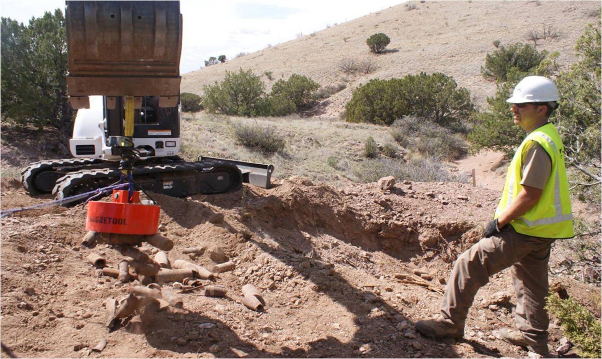 KIRTLAND AIR FORCE BASE, N.M. -- A worker at a munitions response site here uses
an industrial magnet to remove munitions debris from a mine shaft. Courtesy photo