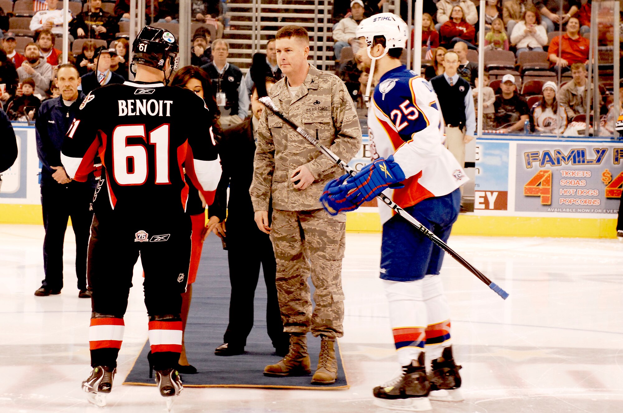 Norfolk, Va. -- Col. Donald Kirkland, 633d Air Base Wing commander, greets team captains Andre Benoit, Binghamton Senators, and Chris Durno, Norfolk Admirals, before tossing the puck during military appreciation night Feb. 4. The Norfolk Admirals hosted the Binghamton Senators at Norfolk Scope Arena and defeated the Senators, 4-3, in overtime.  (U.S. Air force photo/Airman 1st Class Kayla Newman)(RELEASED)