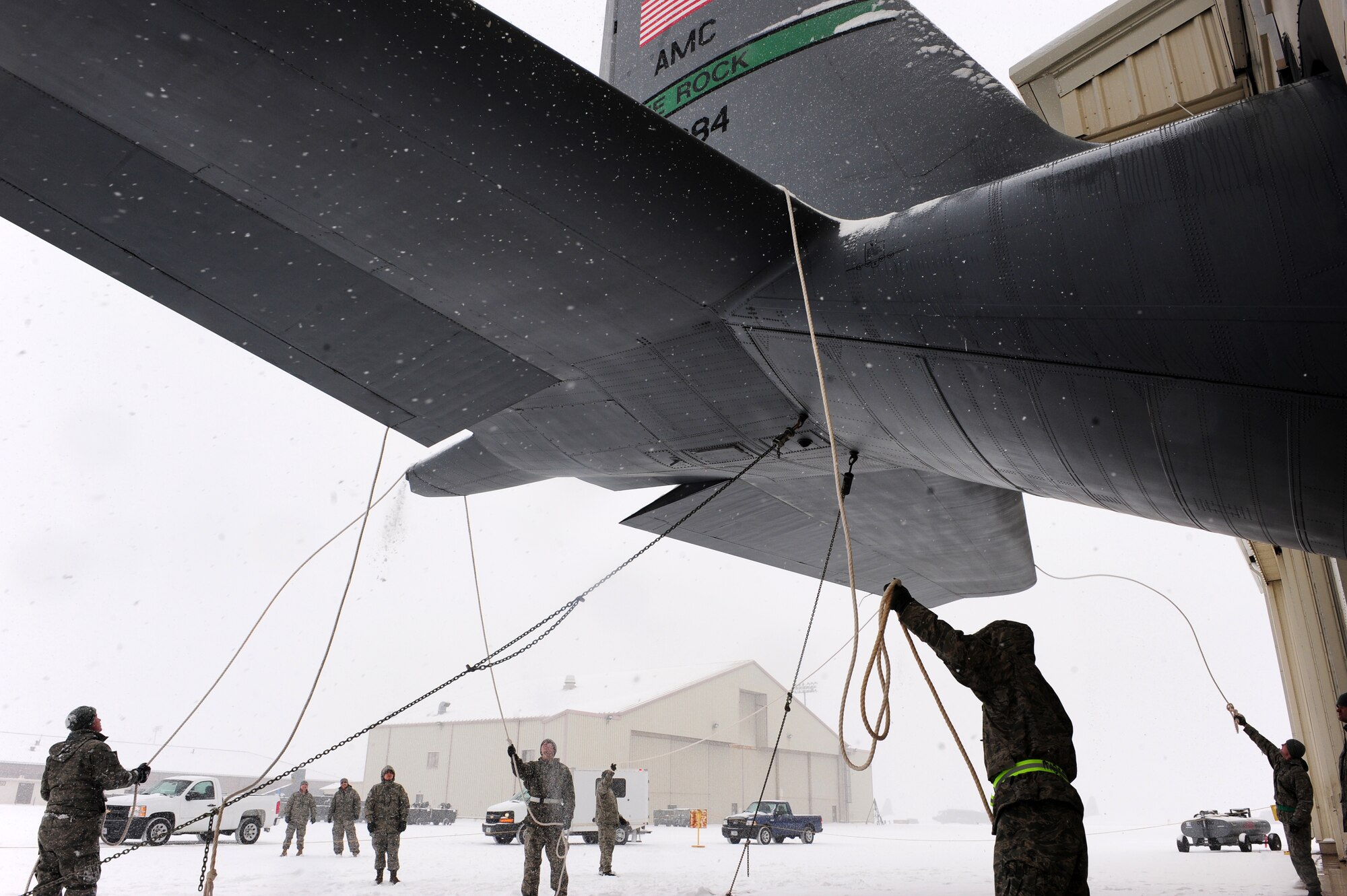 Airmen from the 19th Aircraft Maintenance Squadron remove snow from C-130s Feb. 9, 2011 at Little Rock Air Force Base, Ark. The base was expected to receive six to twelve inches of snow that Airmen had to remove from planes. (Photo by U.S. Air Force Senior Airman Jim Araos)