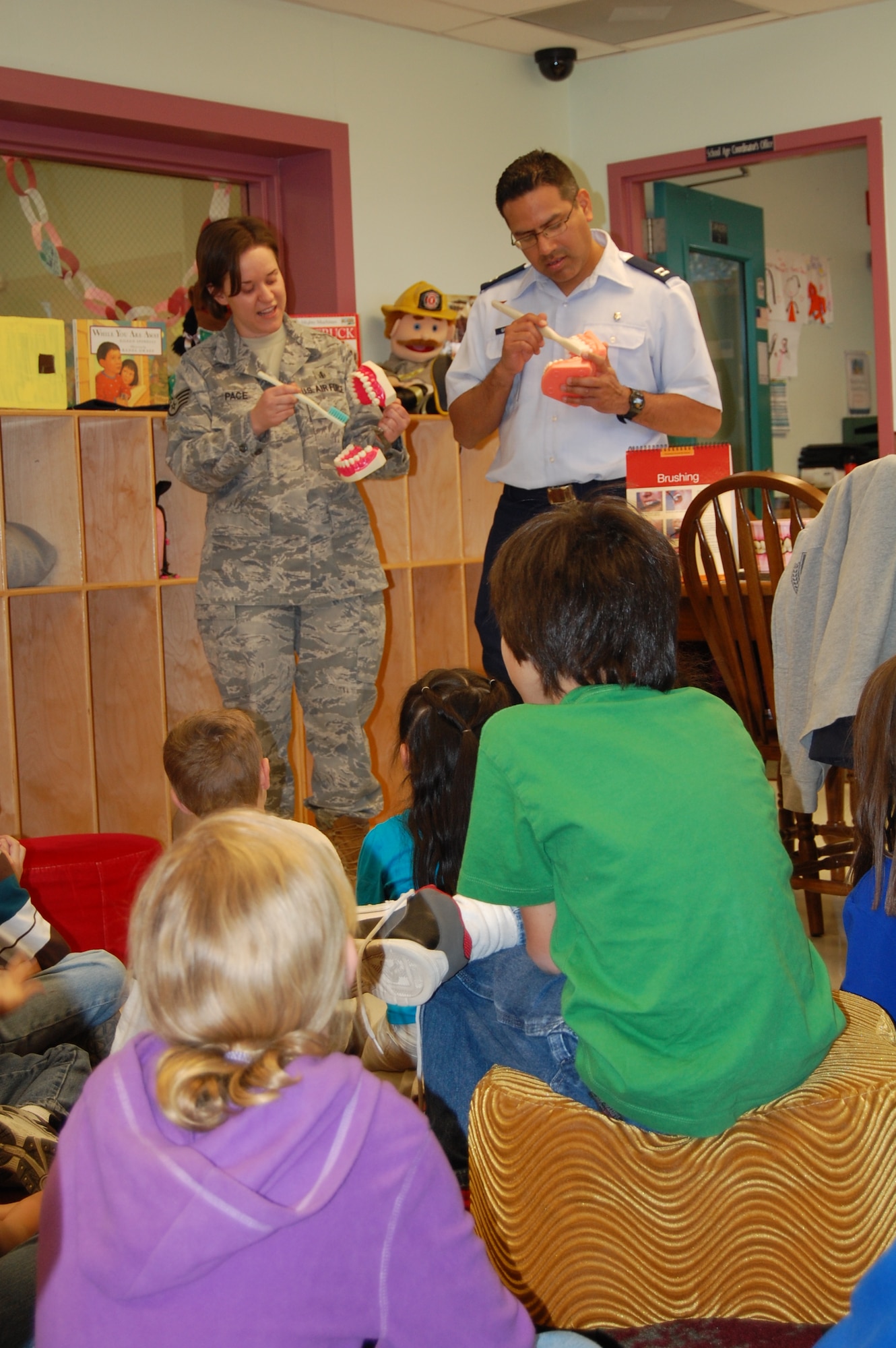 LAUGHLIN AIR FORCE BASE, Texas – Captain Edward Gonzalez and Staff Sgt. Lynnette Pace, both of the 47th Medical Operations Squadron, demonstrate the proper technique for brushing teeth to children at Laughlin’s Youth Center Feb. 7. The demonstration was to raise awareness for Feb. being National Children’s Dental Health Month. (U.S. Air Force photo by 2nd Lt. Ashley Wolfe)