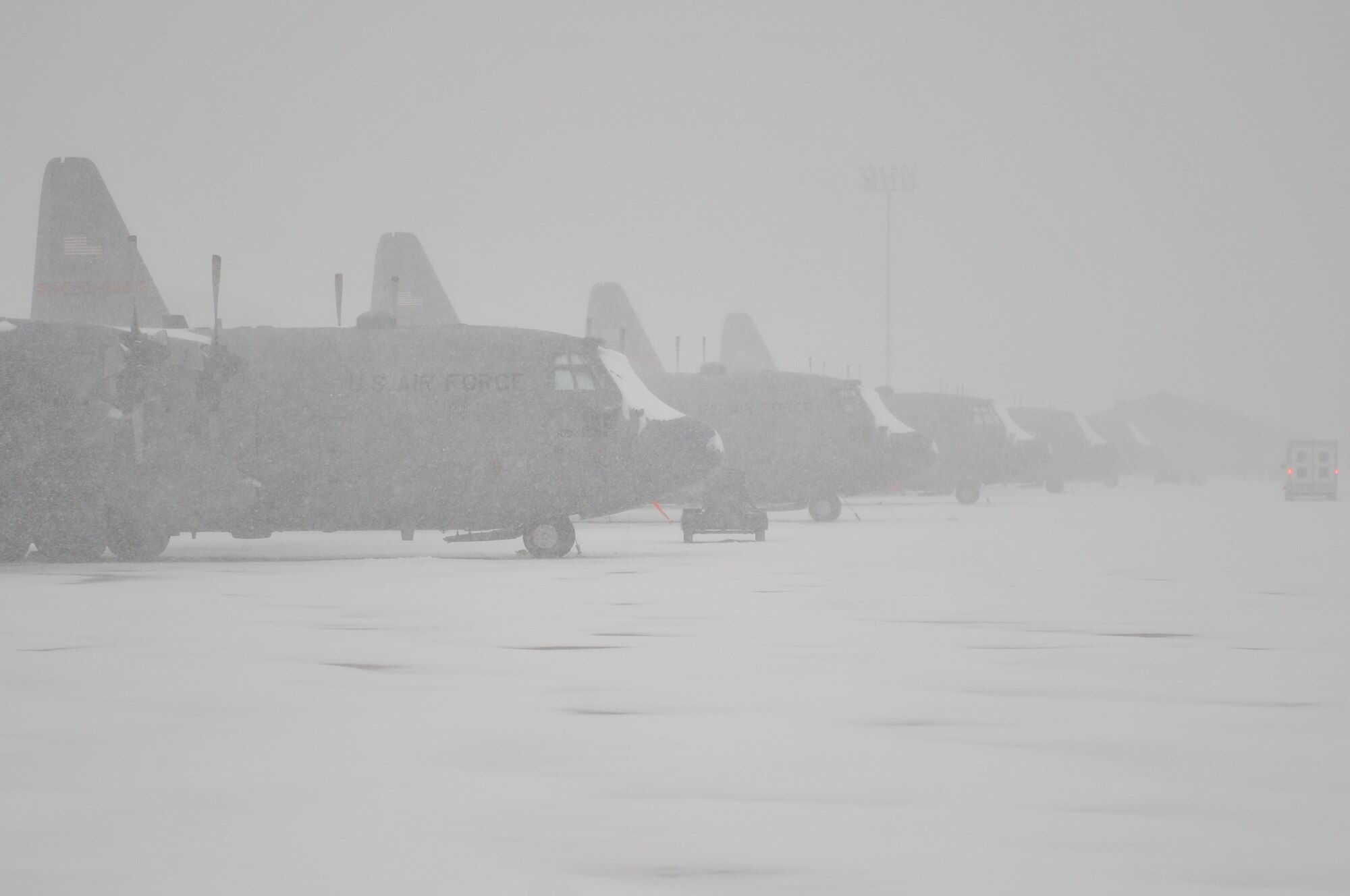 A snow plow attempts to keep the base flight line clear, at Little Rock Air Force Base, Ark., Feb. 9, 2011. The winter storm limited flying operations of the base. (U.S. Air Force photo by Airman 1st Class Rusty Frank)
