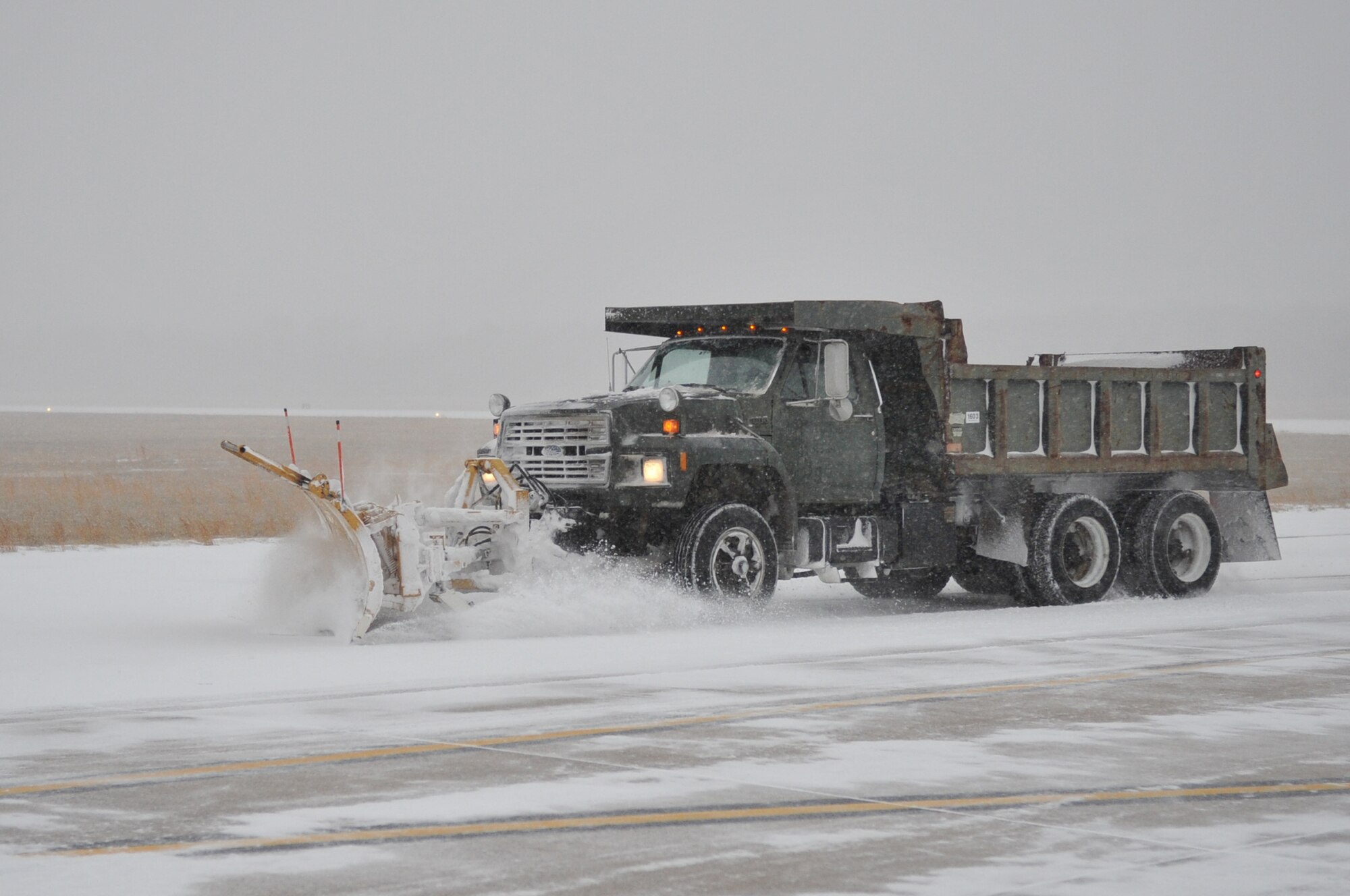 A snow plow clears snow to keep the base flightline clear, at Little Rock Air Force Base, Ark., Feb. 9, 2011. The winter storm limited flying operations. (U.S. Air Force photo by Airman 1st Class Rusty Frank)