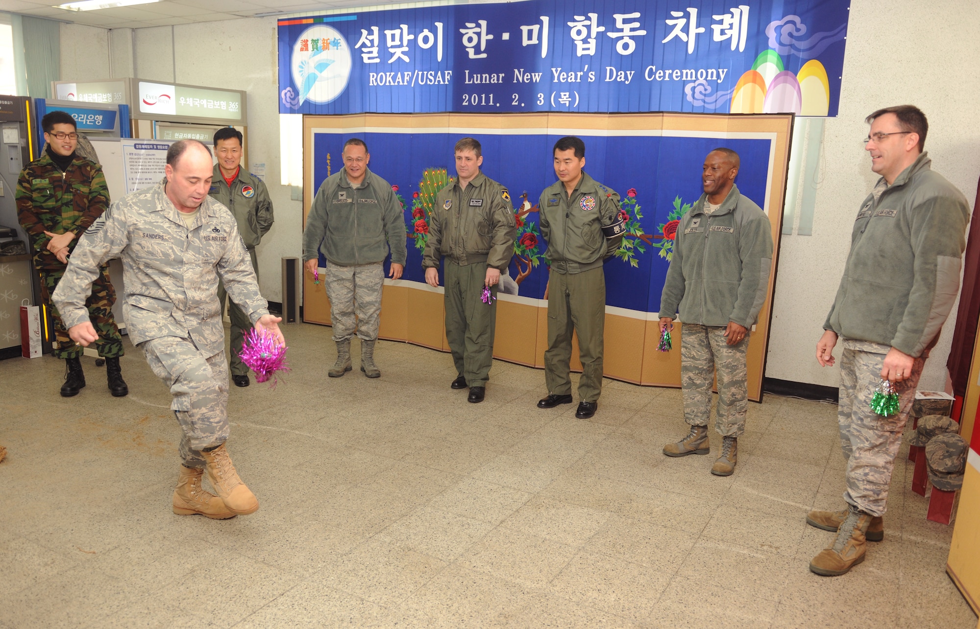 Chief Master Sgt. James Sanders plays the traditional Korean game of chegi during a Lunar New Year ceremony Feb. 3, 2011, in the South Korean air force base exchange. The combined 8th Fighter Wing and South Korean air force 38th Fighter Group ceremony included a memorial service, ceremonial bowing, a traditional Korean breakfast and traditional games. Chief Sanders is the 8th Fighter Wing command chief. (U.S. Air Force photo/Senior Airman Ciara Wymbs)