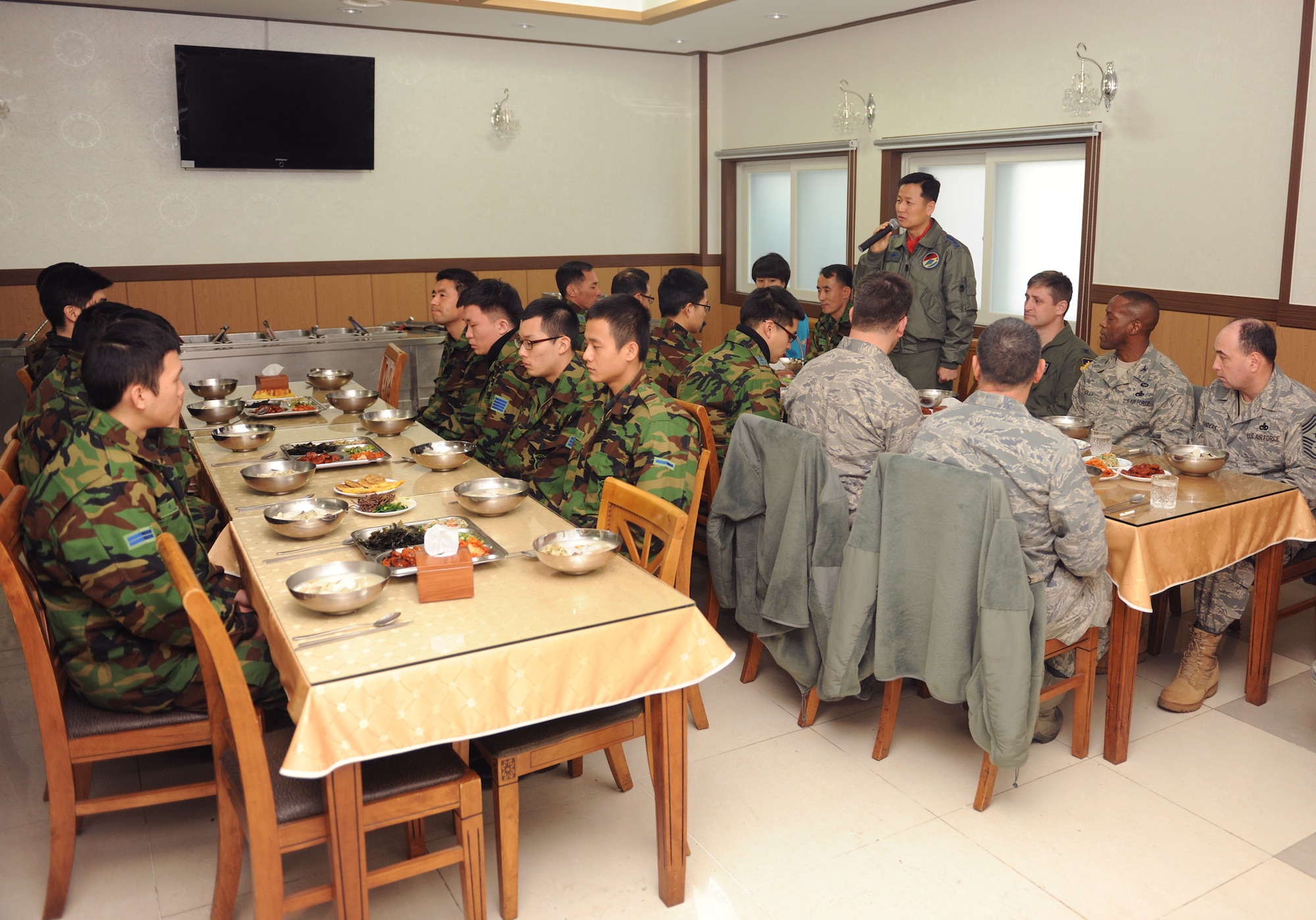 South Korean air force Col. Jung Sang-Hwa speaks to 8th Fighter Wing and South Korean air force 38th Fighter Group airmen during a Lunar New Year ceremony Feb. 3, 2011, in the South Korean air force base exchange. The combined 8th FW and 38th FG ceremony included a memorial service, ceremonial bowing, a traditional Korean breakfast and traditional games. Colonel Sang-Hwa is the 38th Fighter Group commander. (U.S. Air Force photo/Senior Airman Ciara Wymbs)