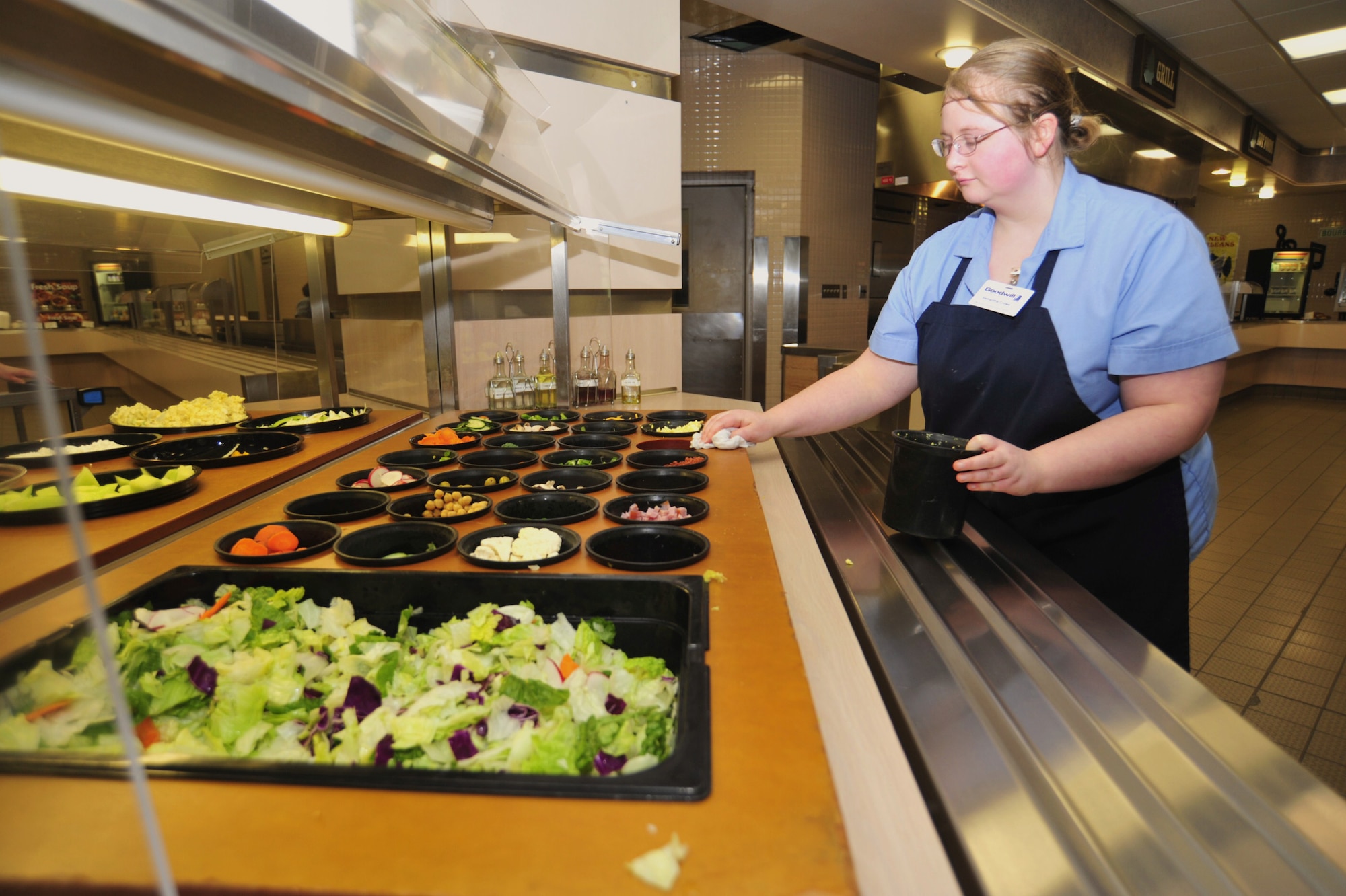 Samantha Crowe, Goodwill Services employee, keeps the salad bar neat and tidy Feb. 1 at the McChord Field dining facility, Joint Base Lewis-McChord, Wash. The dining facility offers six different fruits at each meal, and a salad bar with a wide variety of nutritious and delicious food choices. (U.S. Air Force photo/Airman 1st Class Leah Young)