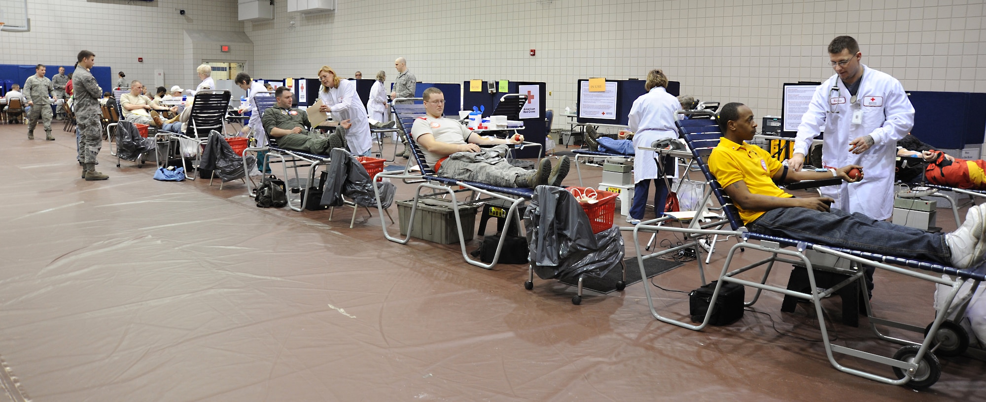 Team McConnell members donate blood at the Robert J. Dole Community Center Feb. 4, 2011, McConnell Air Force Base, Kan. A total of 130 pints of blood were collected. The Company Grade Officer Council organized the event with the assistance of the Airman and Family Readiness Center, McConnell’s Officer Spouses Club and Enlisted Spouses Club. (U.S. Air Force photo/Senior Airman Maria A. Ruiz)