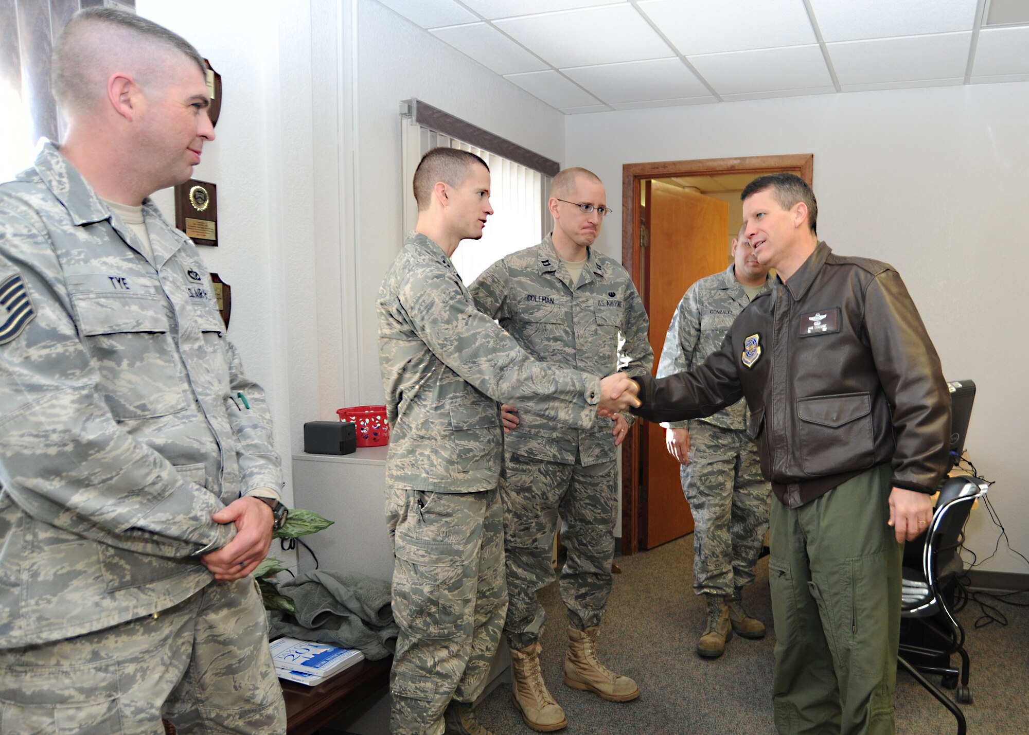 Col. Jamie Crowhurst, 22nd Air Refueling Wing commander, shakes hands with legal office members and volunteers at the McConnell Tax Center Feb. 3, 2011, McConnell Air Force Base, Kan.  The Tax Center is open until April 15, and has about fifteen volunteers helping military members, dependents and retirees file their tax returns. In 2010, the Tax Center saved taxpayers approximately $320,000 in tax preparation fees, and helped them claim nearly $3 million in refunds. (U.S. Air Force photo/Senior Airman Maria A. Ruiz)