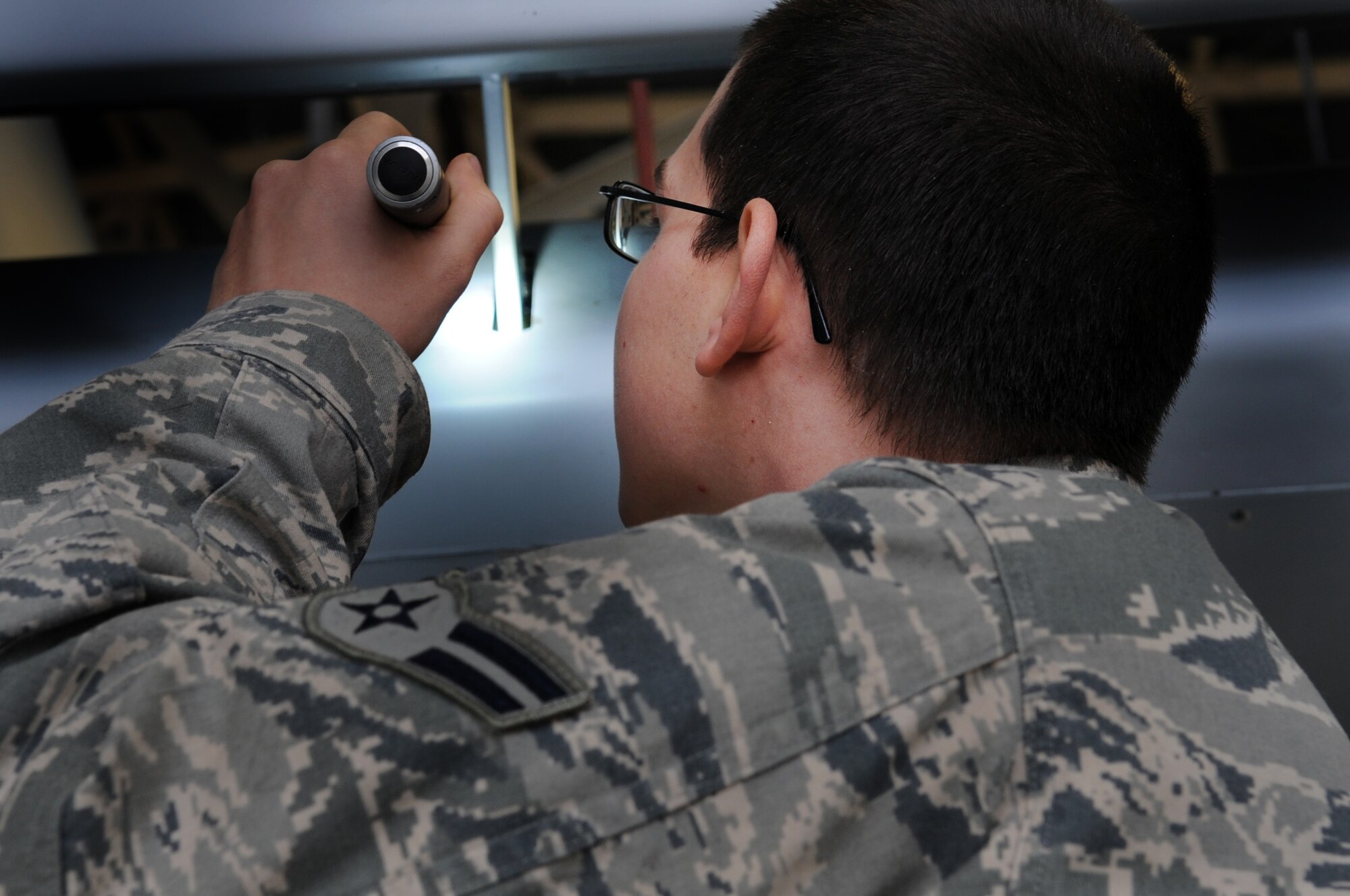 MOODY AIR FORCE BASE, Ga. -- Airman 1st Class Jeffery Fagan, 23rd Equipment Maintenance Squadron phase inspector, closely inspects an A-10C Thunderbolt II Feb. 9. Part of this routine inspection is to ensure that all bolts and screws are secure on the aircraft. (U.S. Air Force photo/Airman 1st Class Douglas Ellis)(RELEASED)
