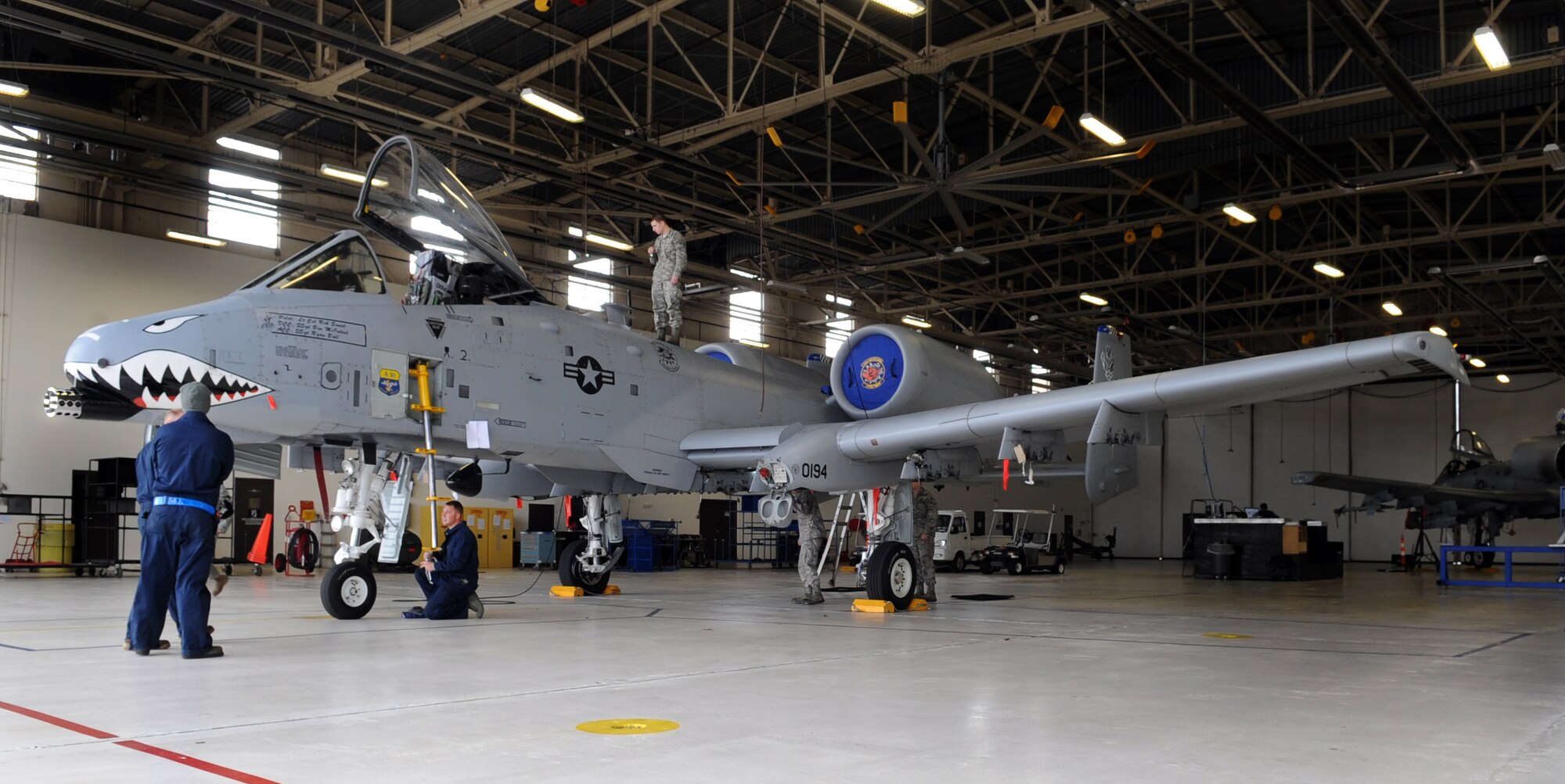 MOODY AIR FORCE BASE, Ga. -- Members from the 23rd Equipment Maintenance Squadron inspect an A-10C Thunderbolt II as members from the 23rd Aircraft Maintenance Squadron wait to tow the aircraft Feb. 9. This was a routine inspection to ensure that the aircraft is safe to tow. (U.S. Air Force photo/Airman 1st Class Douglas Ellis)(RELEASED)
