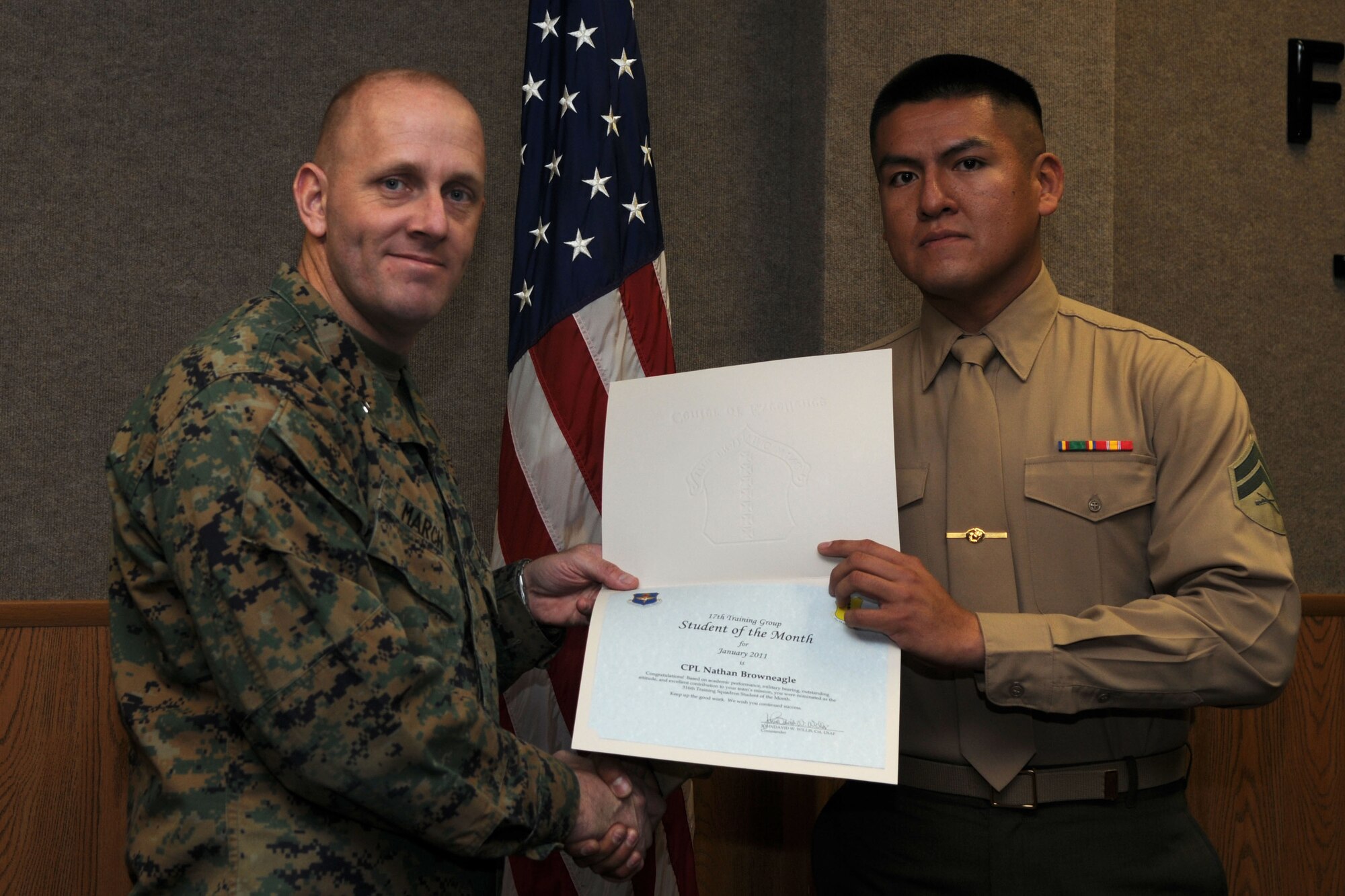 GOODFELLOW AIR FORCE BASE, Texas--  Marine Cpl. Nathan Browneagle, 316th Training Squadron, accepts his January Student of the Month award from Marine Capt. Douglas March,Marine Corps Detachment Commanding Officer, Feb. 4. (U.S. Air Force photo/Staff Sgt. Heather Rodgers) 