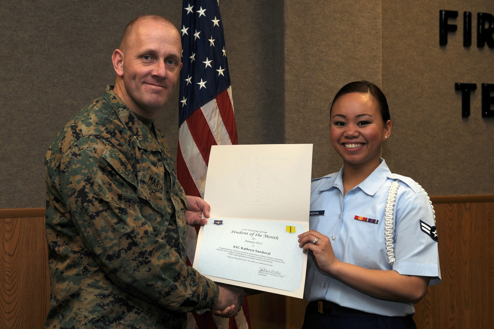 GOODFELLOW AIR FORCE BASE, Texas--  Airman 1st Class Kathryn Sandoval, 315th Training Squadron, accepts her January Student of the Month award from Marine Capt. Douglas March,Marine Corps Detachment Commanding Officer, Feb. 4. (U.S. Air Force photo/Staff Sgt. Heather Rodgers) 