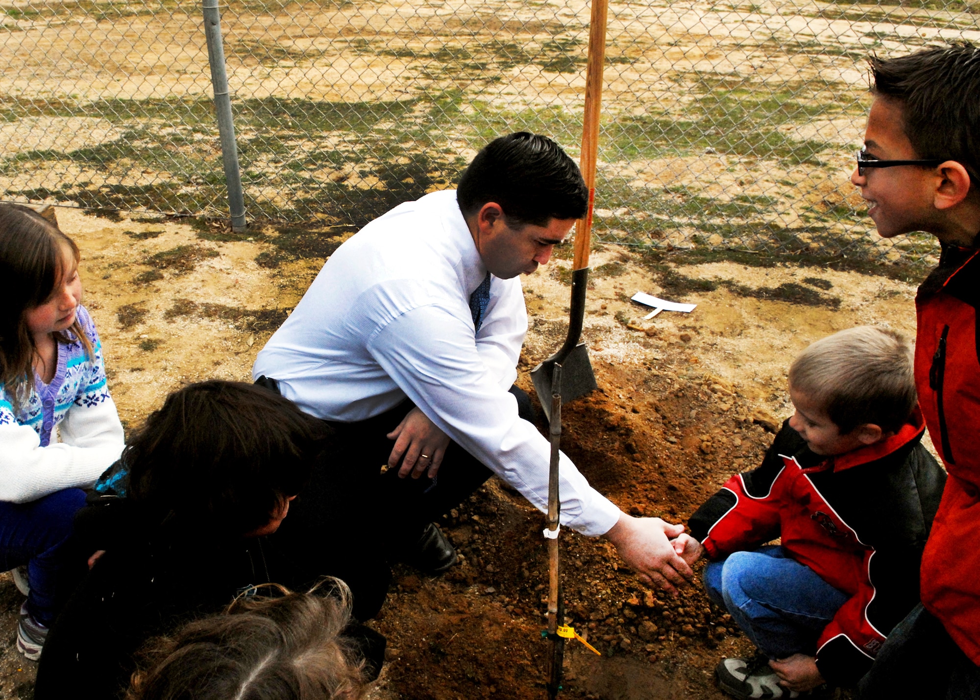 Kevin Cordes, Branch Elementary School principal, acknowledges a job well done by students after planting a fig tree in the school's new outdoor classroom. Now open for instruction, the “Branch Garden of Learning” is intended to give students an opportunity for hands-on learning and real-world applications of mathematics, science, social studies and language arts. (Air Force photo by Kate Blais)