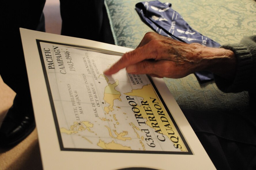 Louisville, Ky. -- The former and present commander of the 63rd Air Refueling Squadron, now based out of MacDill Air Force Base, Fla., bridged a gap of more than 60 years to share their stories.  The unit began as the 63rd Troop Carrier Squadron during World War II.  One of the unit's first commanders, Col. George Kinnaird, traces the flight paths he used to avoid Japanese anti-aircraft fire over the Solomon Islands. (Official U.S. Air Force photo by Staff Sgt. Shawn C. Rhodes)