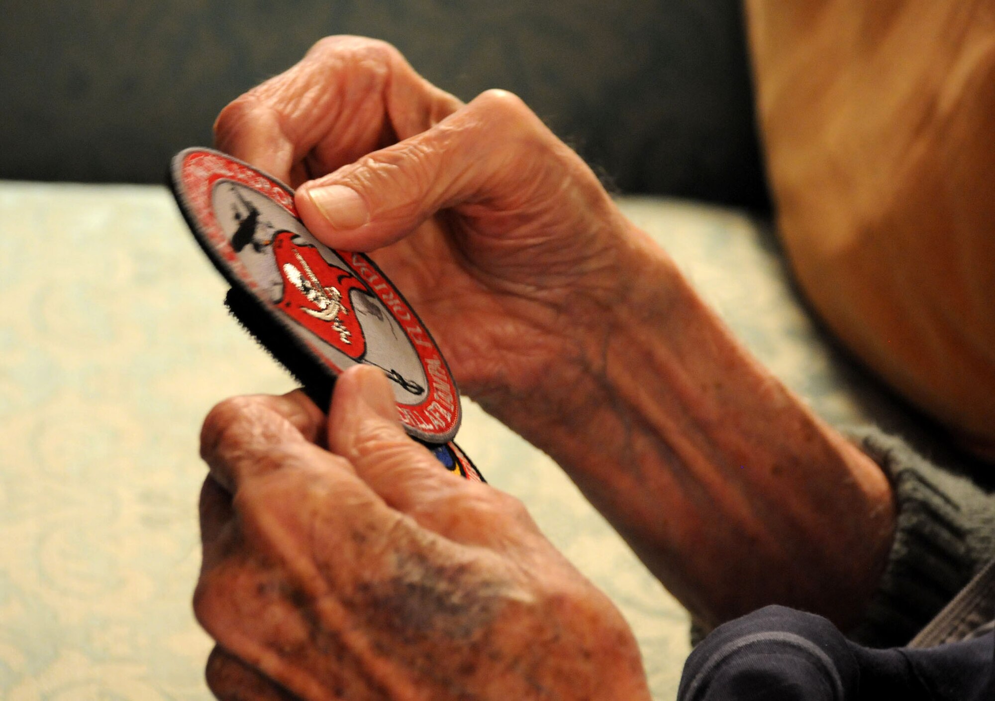 Louisville, Ky. -- Things change with time.  Colonel George Kinnaird, once a pilot and commander of the 63rd Troop Carrier Squadron, watched aircraft and the Air Force change over the last 71 years.  Here, he examines the unit patch of what his squadron became - the 63rd Air Refueling Squadron, now based at MacDill Air Force Base, Fla.  (Official U.S. Air Force photo by Staff Sgt. Shawn Rhodes) 