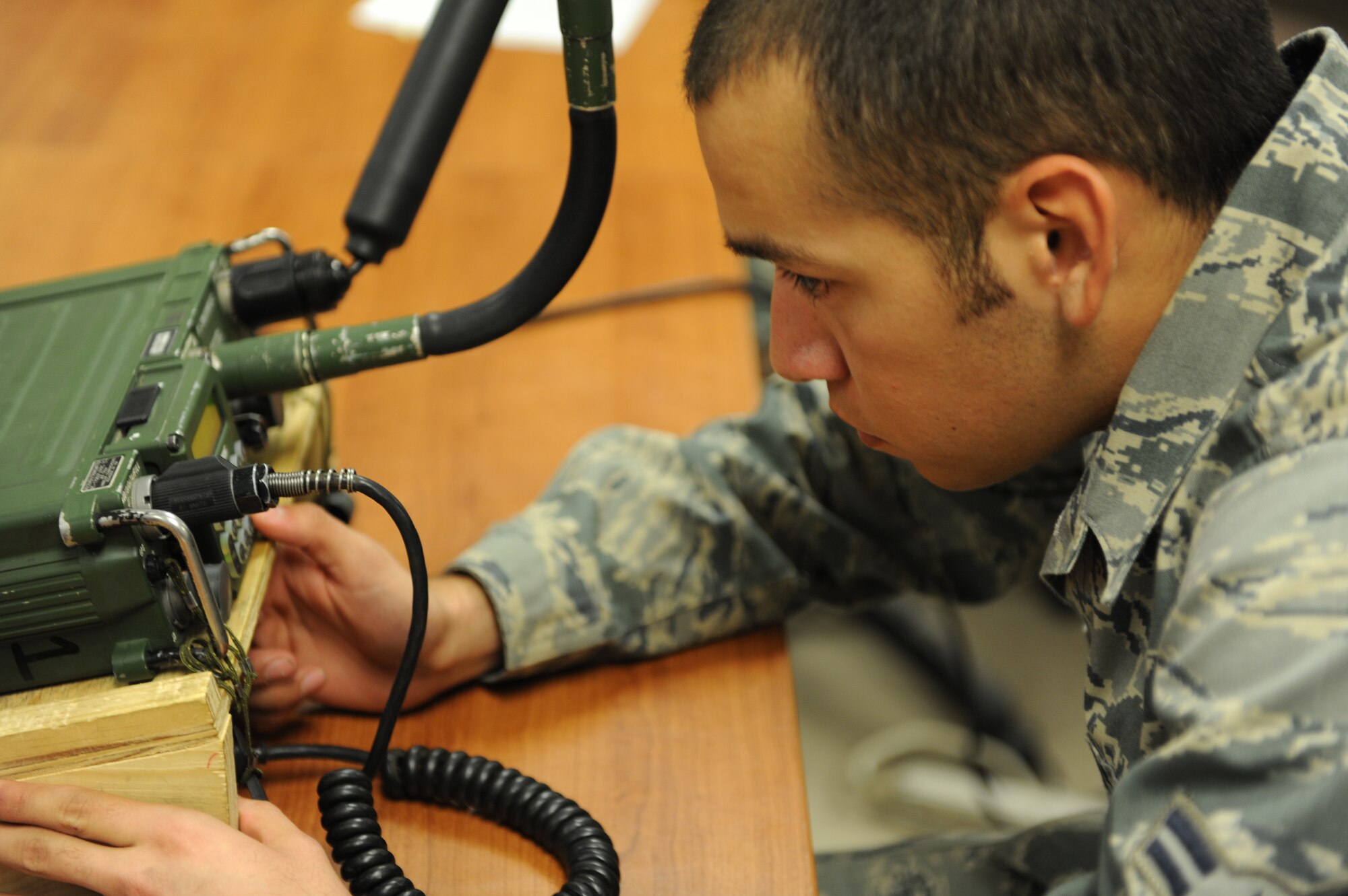 U.S. Air Force Airman 1st Class Alan Cisneros, a member of Tactical Air Control Party class Falcon 86, assembles and trouble shoots a radio during a progress check at the TACP school house, Hurlburt Field, Fla., Jan. 26, 2011. The TACP tactical training school involves rigorous academic and physical training standards. (U.S. Air Force photo by Airman 1st Class Caitlin O’Neil-McKeown/RELEASED) 





