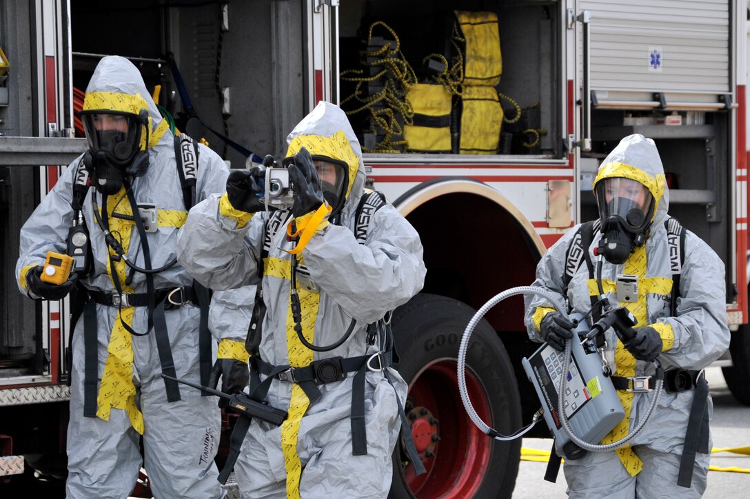 Airmen from the 779th Medical Group bioenvironmental flight move towards the simulated fuel spill while testing the air for hazards using a gas meter and a toxic vapor analyzer, Feb. 8, at Joint Base Andrews. Personnel all over Joint Base Andrews participated in the exercise which consisted of a fuel truck crashing into a bus carrying passengers. The exercise was conducted to test the emergency response actions of the installation’s first responders as well as prepare Joint Base Andrews for the upcoming Compliance Inspection.  (U.S. Air Force photo/ Senior Airman Perry Aston)