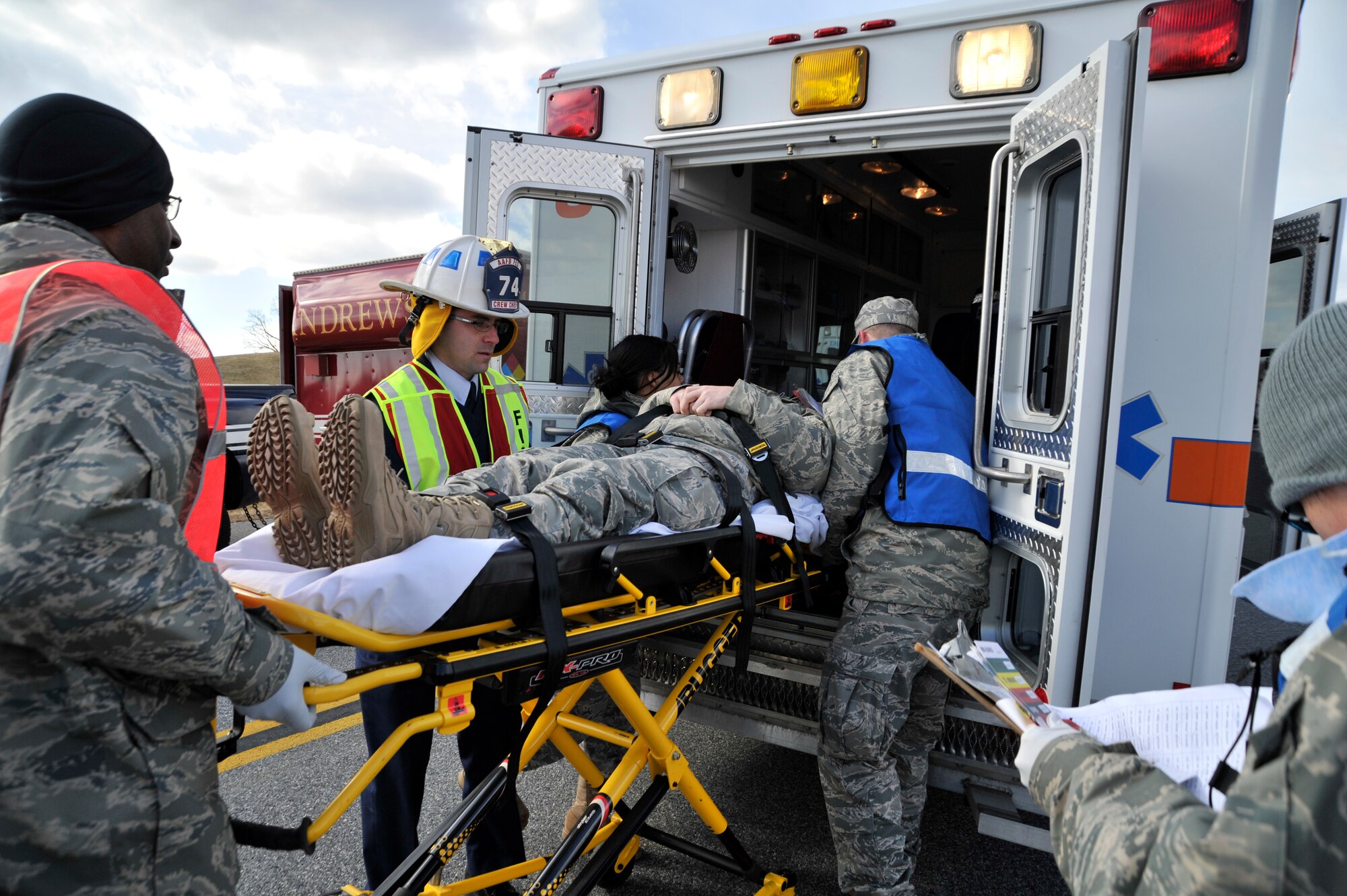 779th Medical Group and 11th Wing Airmen load a simulated unconscious victim into an ambulance to be transported to Malcolm Grow Medical Center during an emergency exercise, Feb. 8, at Joint Base Andrews. Personnel all over Joint Base Andrews participated in the exercise which consisted of a fuel truck crashing into a bus carrying passengers. The exercise was conducted to test the emergency response actions of the installation’s first responders as well as prepare Joint Base Andrews for the upcoming Compliance Inspection.  (U.S. Air Force photo/ Senior Airman Perry Aston)