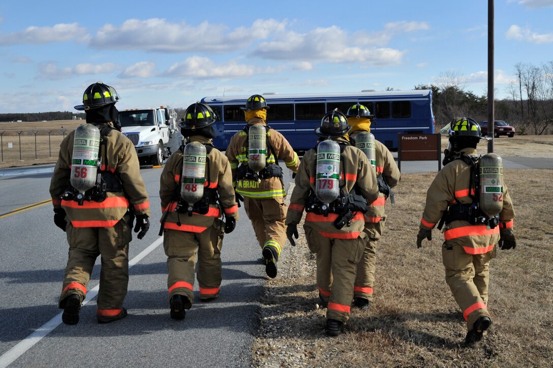 11th Civil Engineer Squadron firefighters walk towards a simulated crash site to extricate the victims during an emergency exercise, Feb. 8, at Joint Base Andrews. Personnel all over Joint Base Andrews participated in the exercise which consisted of a fuel truck crashing into a bus carrying passengers. The exercise was conducted to test the emergency response actions of the installation’s first responders as well as prepare Joint Base Andrews for the upcoming Compliance Inspection.  (U.S. Air Force photo/ Senior Airman Perry Aston)