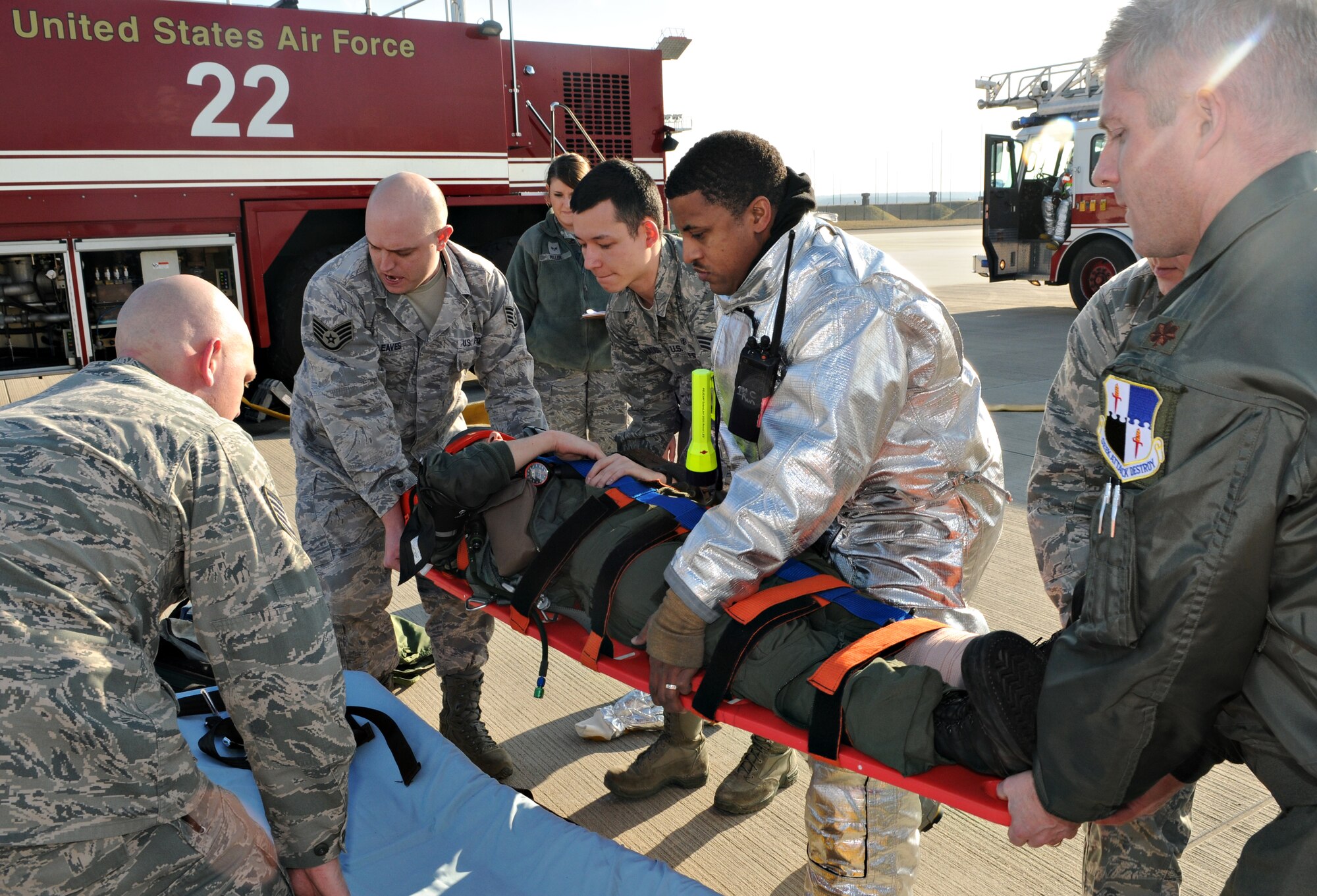 SPANGDAHLEM AIR BASE, Germany – First responders hoist an A-10 Thunderbolt II pilot onto a gurney during a major accident response exercise Feb. 8. The exercise tested base members’ ability to respond to an emergency involving aircraft on the flightline. (U.S. Air Force photo/Staff Sgt. Benjamin Wilson)