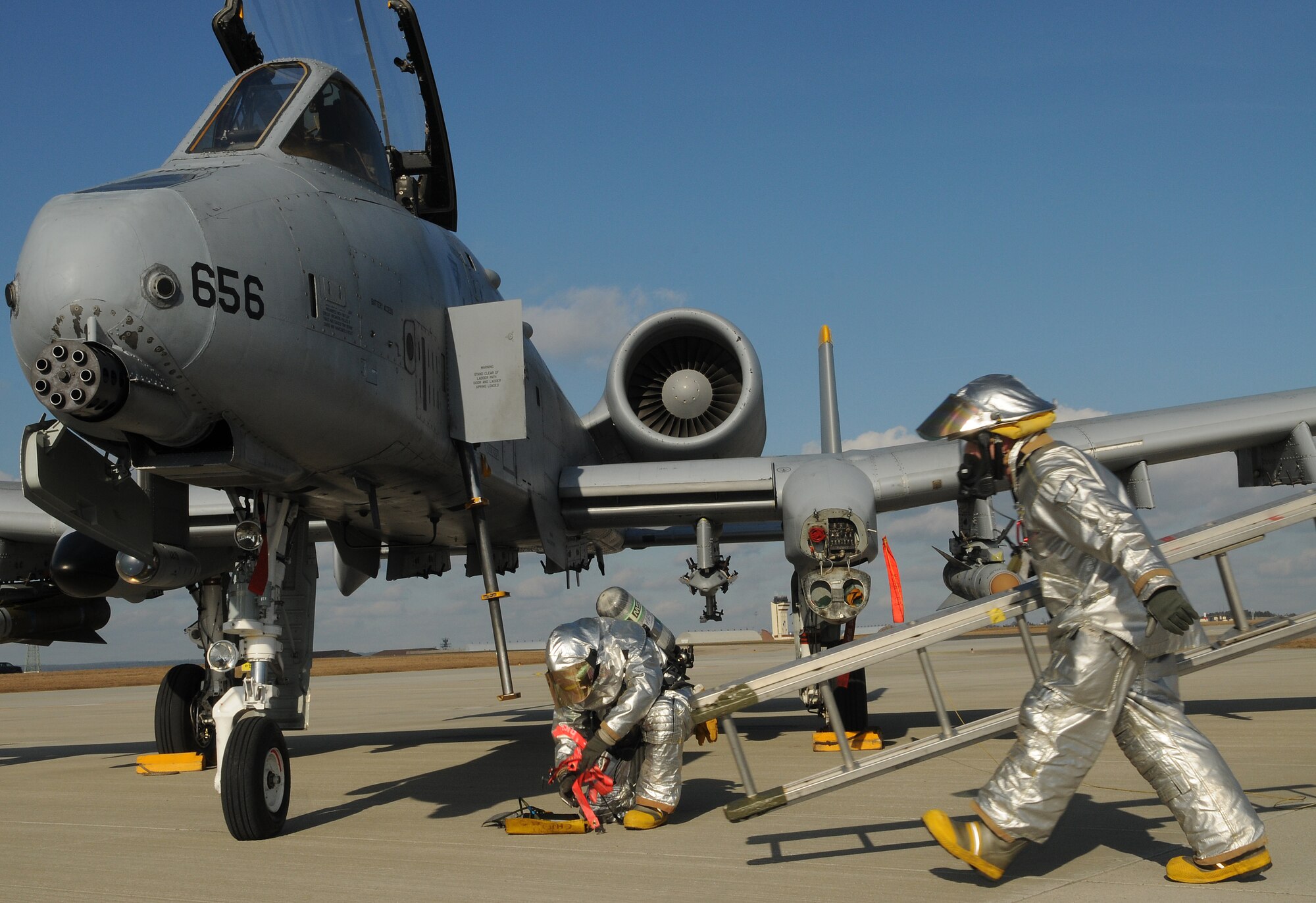 SPANGDAHLEM AIR BASE, Germany – Firefighters from the 52nd Civil Engineer Squadron prepare to extract an A-10 Thunderbolt II pilot from the flight deck during a major accident response exercise Feb. 8. The exercise tested base members’ ability to respond to an emergency involving aircraft on the flightline. (U.S. Air Force photo/Staff Sgt. Benjamin Wilson)